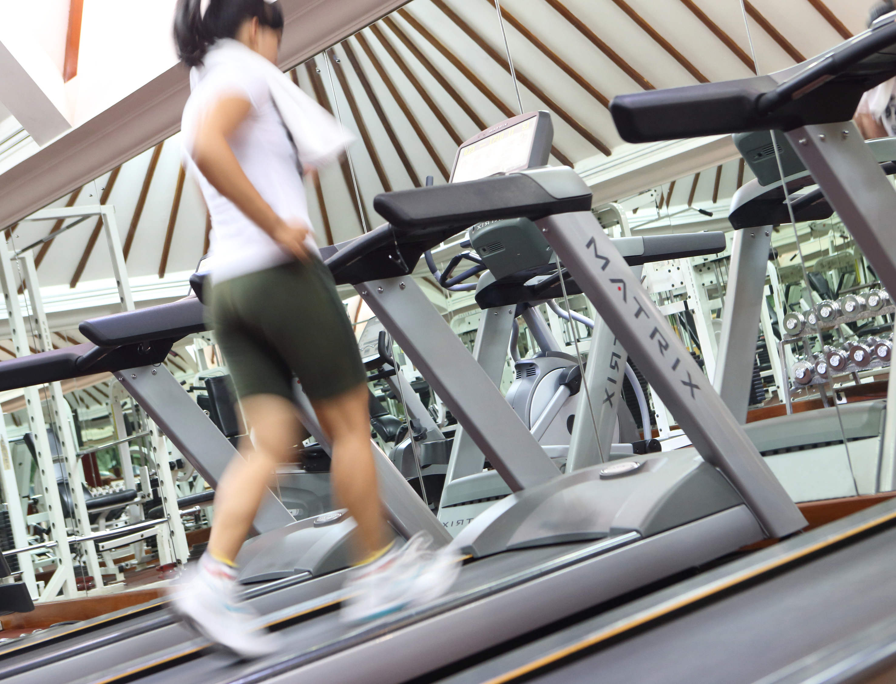 a woman walking on a treadmill