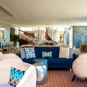 a blue couch and chairs in a lobby