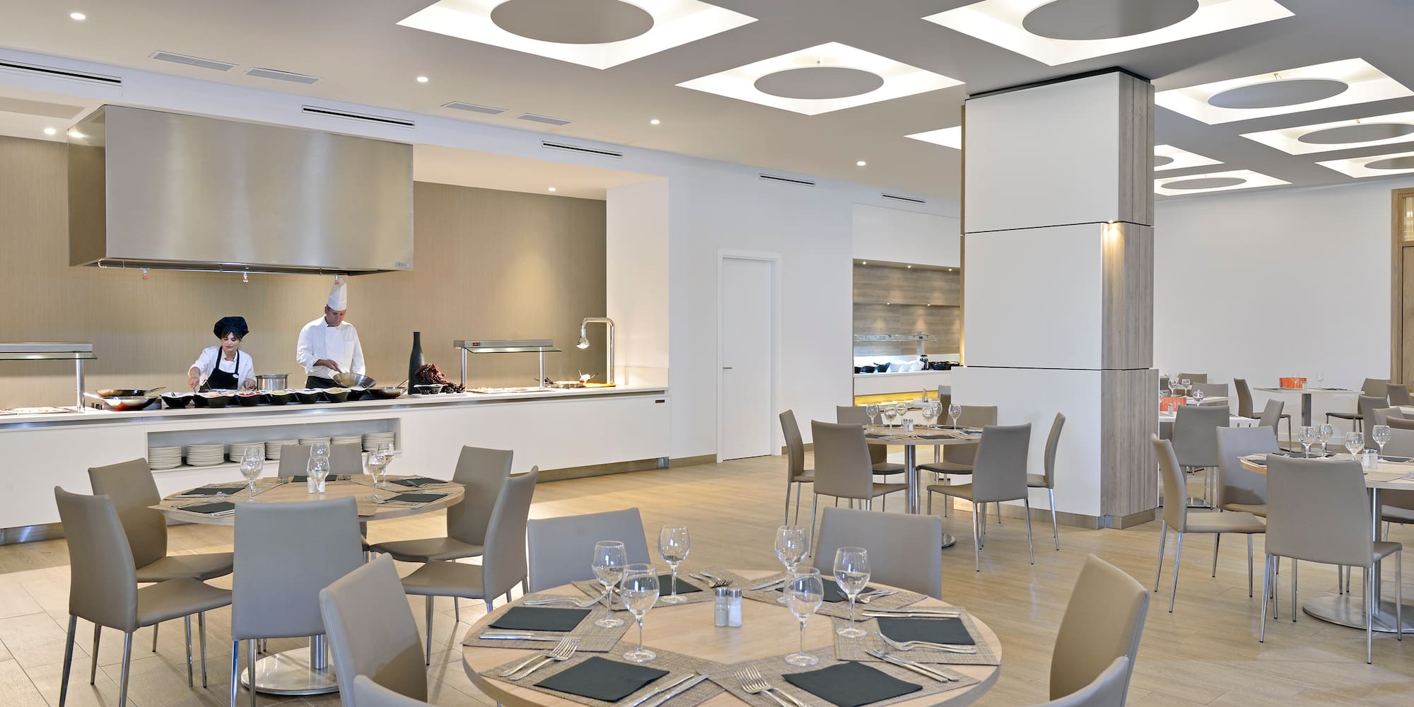 a restaurant with a chef in the background