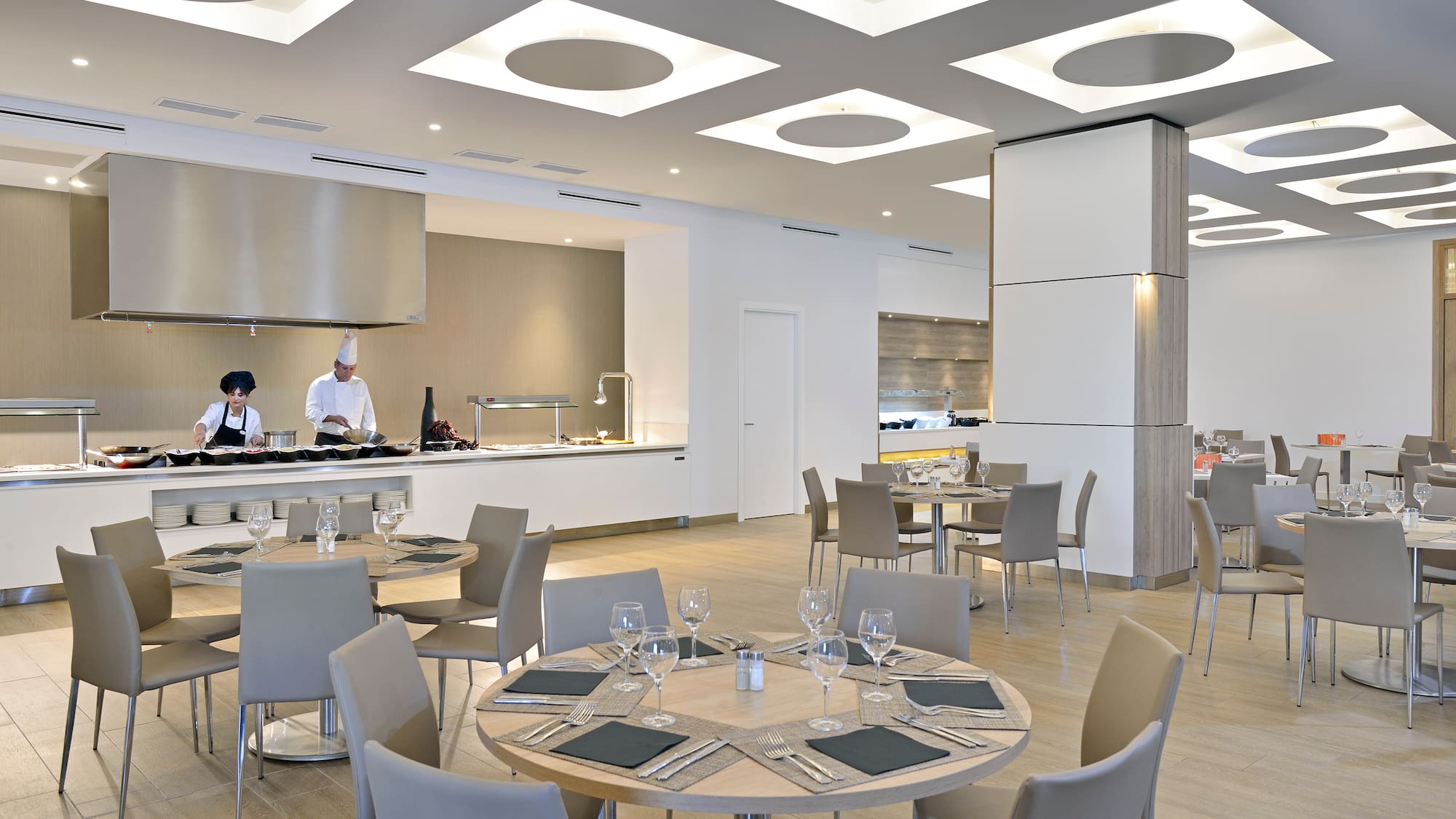 a restaurant with a chef in the background