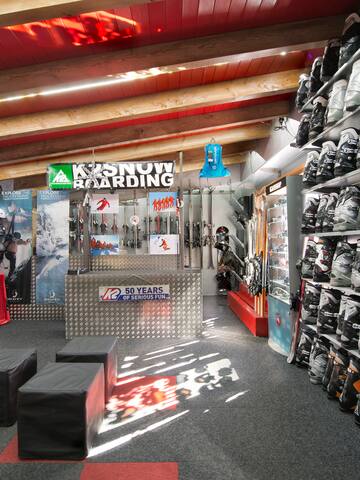 a store with ski gear and skis
