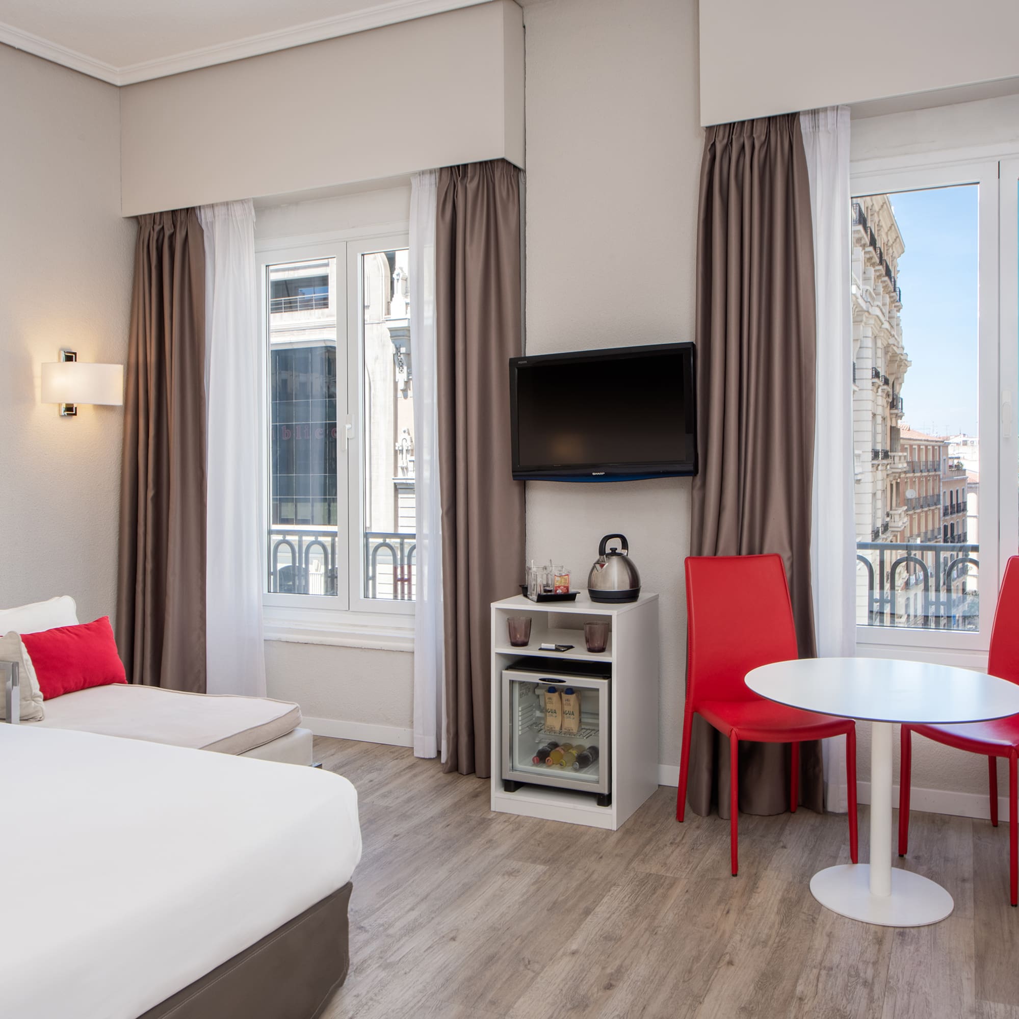 a room with a bed and a table and chairs