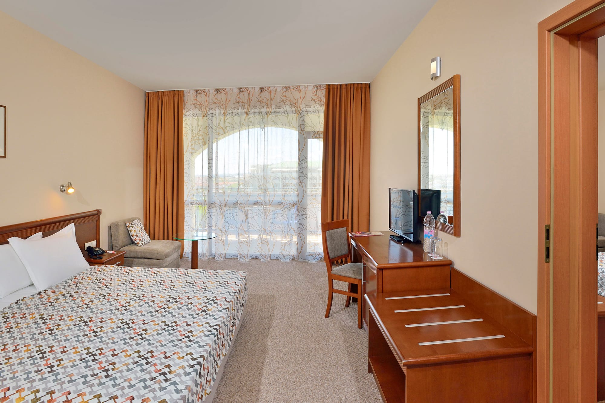 a room with a bed and a desk