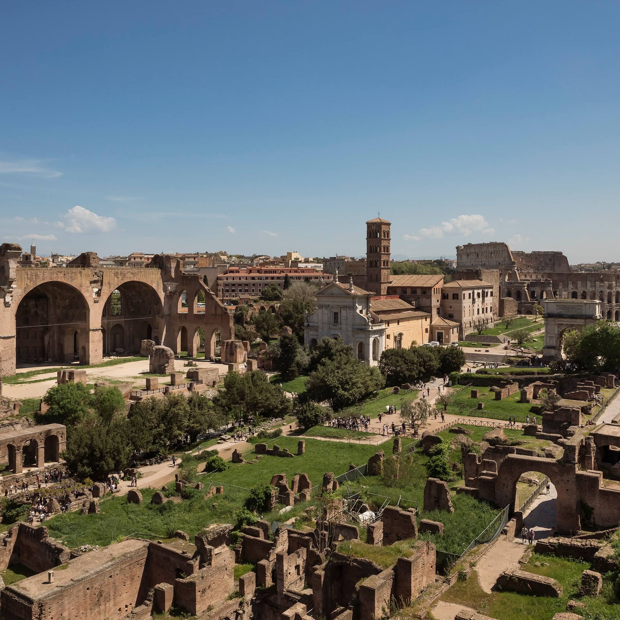an old city with ruins with Roman Forum in the background