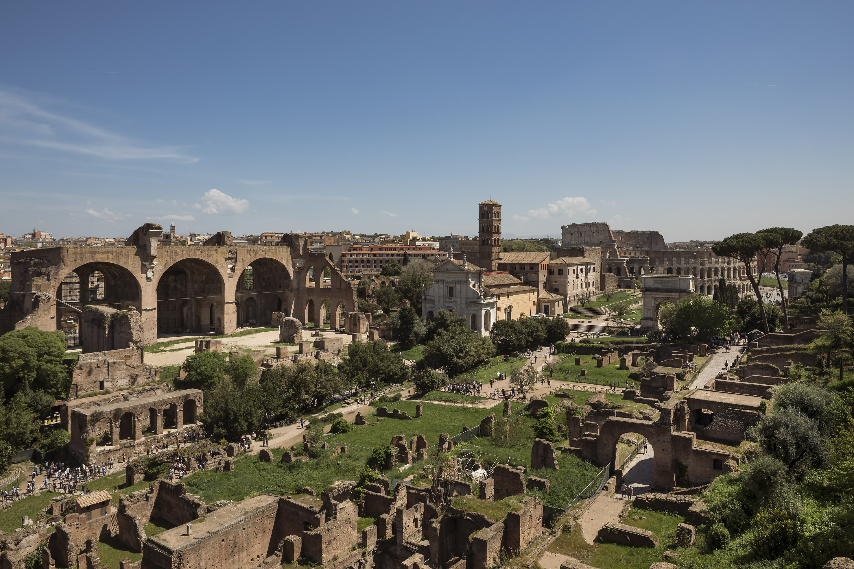 Ancient Roman Forum and Palatine Hill ruins with the Colosseum in Rome, Italy.