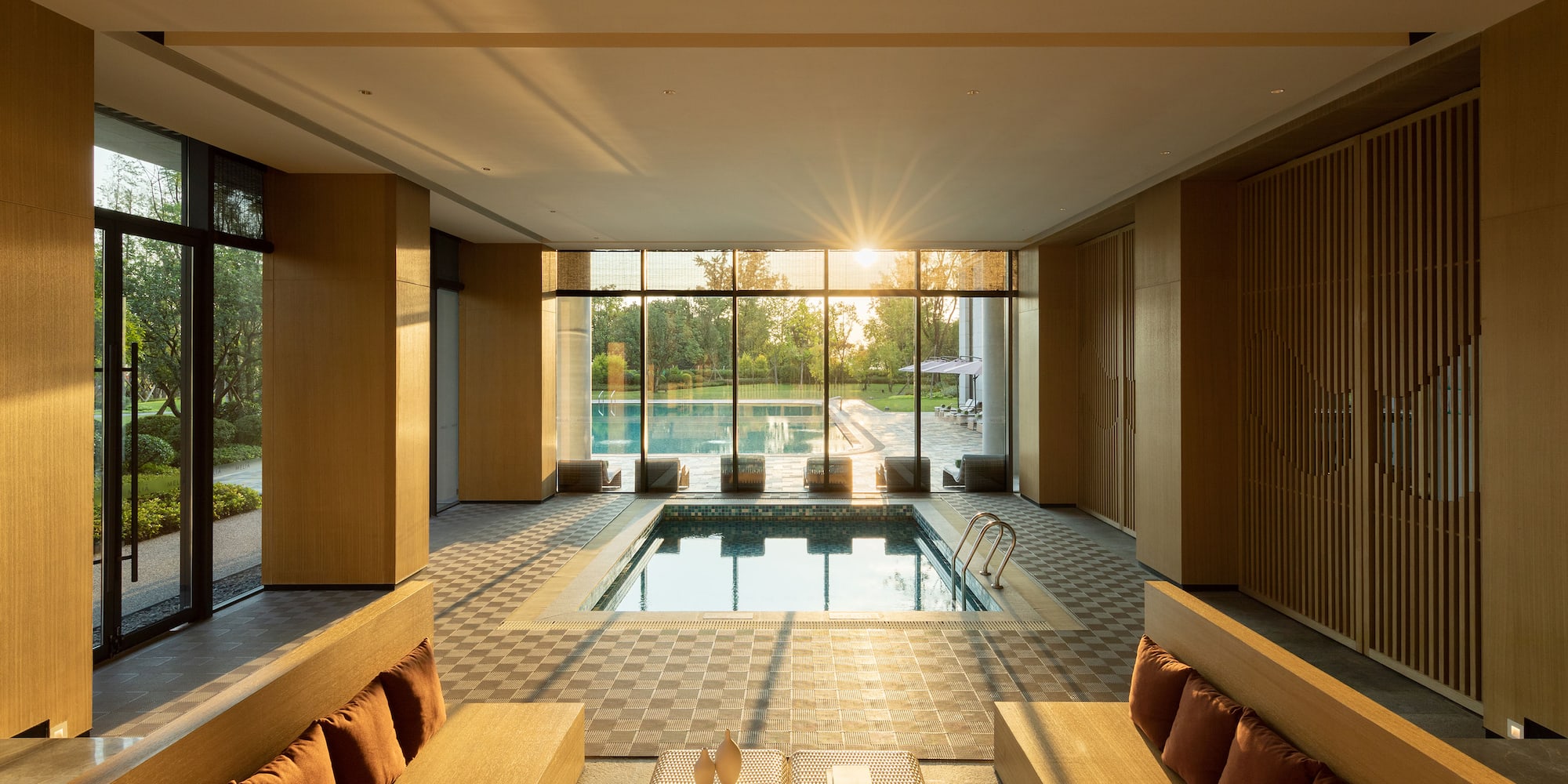 a room with a pool and a bench