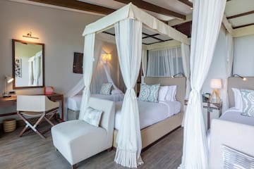 a room with two beds and a canopy over it