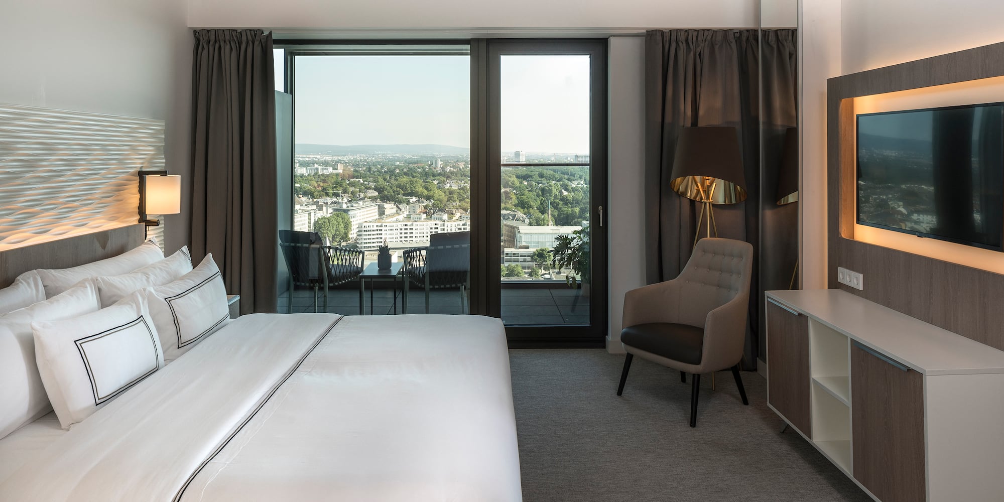 a bedroom with a bed and a chair and a desk