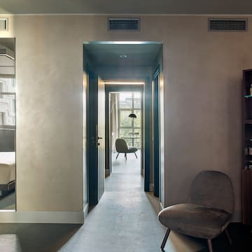 a room with a chair and a bookcase