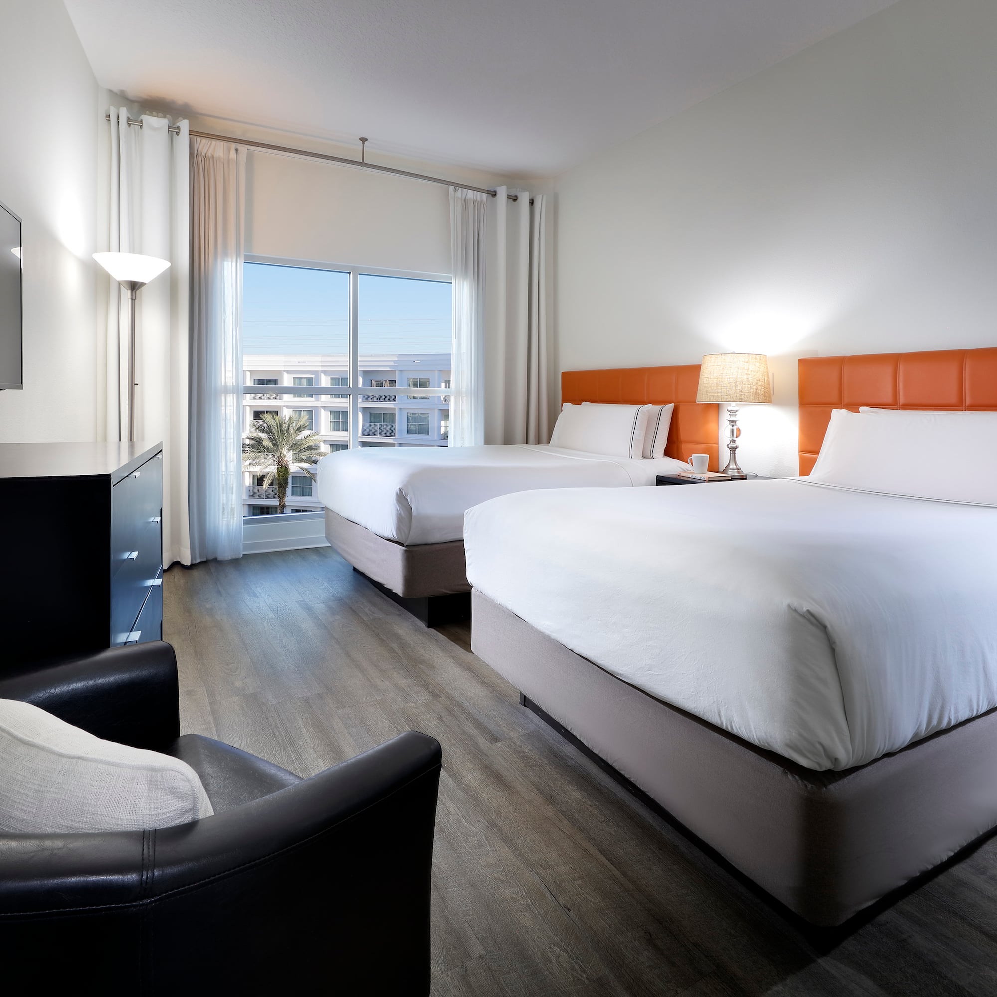 a room with two beds and a television