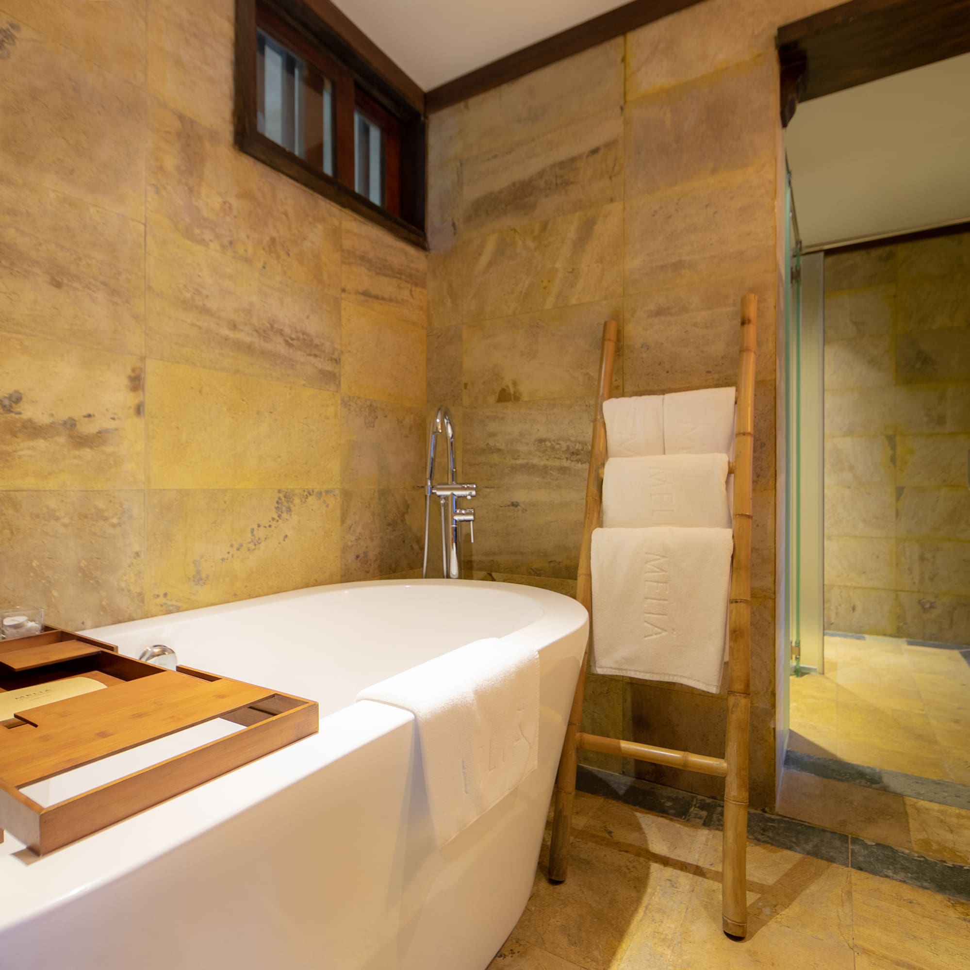 a bathroom with a tub and a wooden ladder