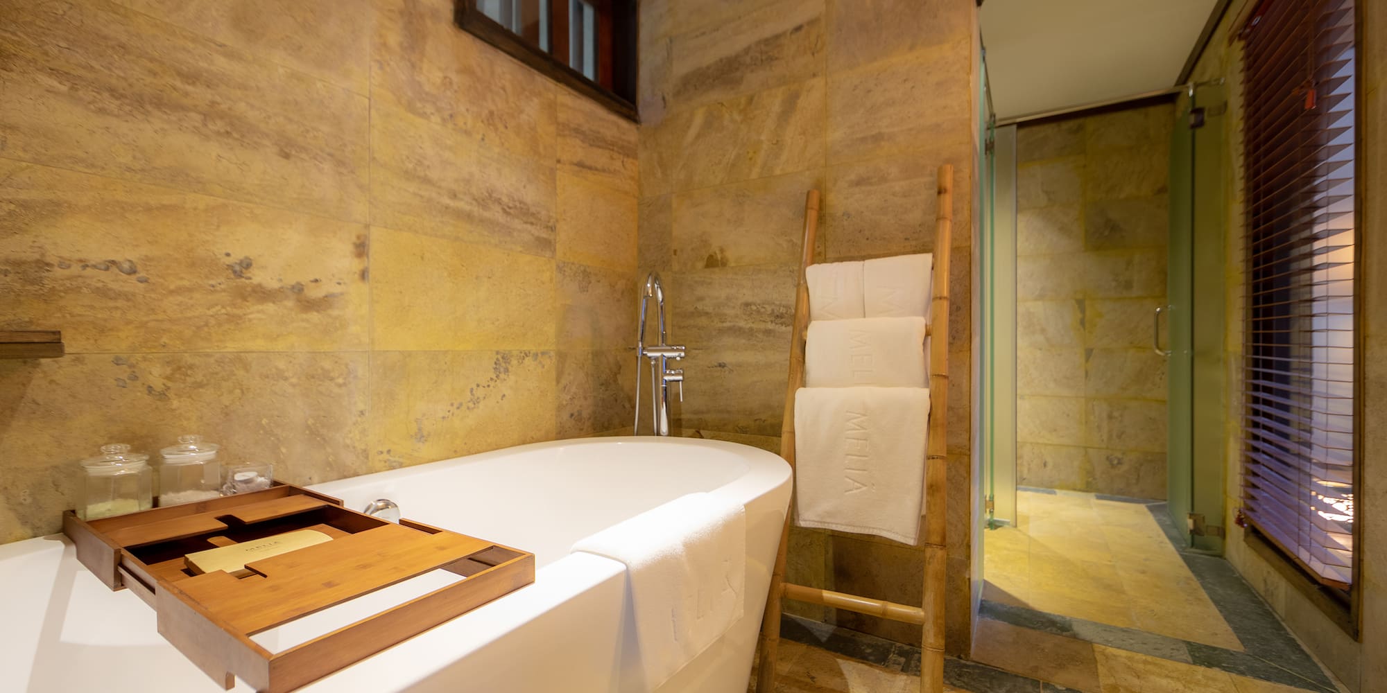 a bathroom with a tub and a wooden ladder