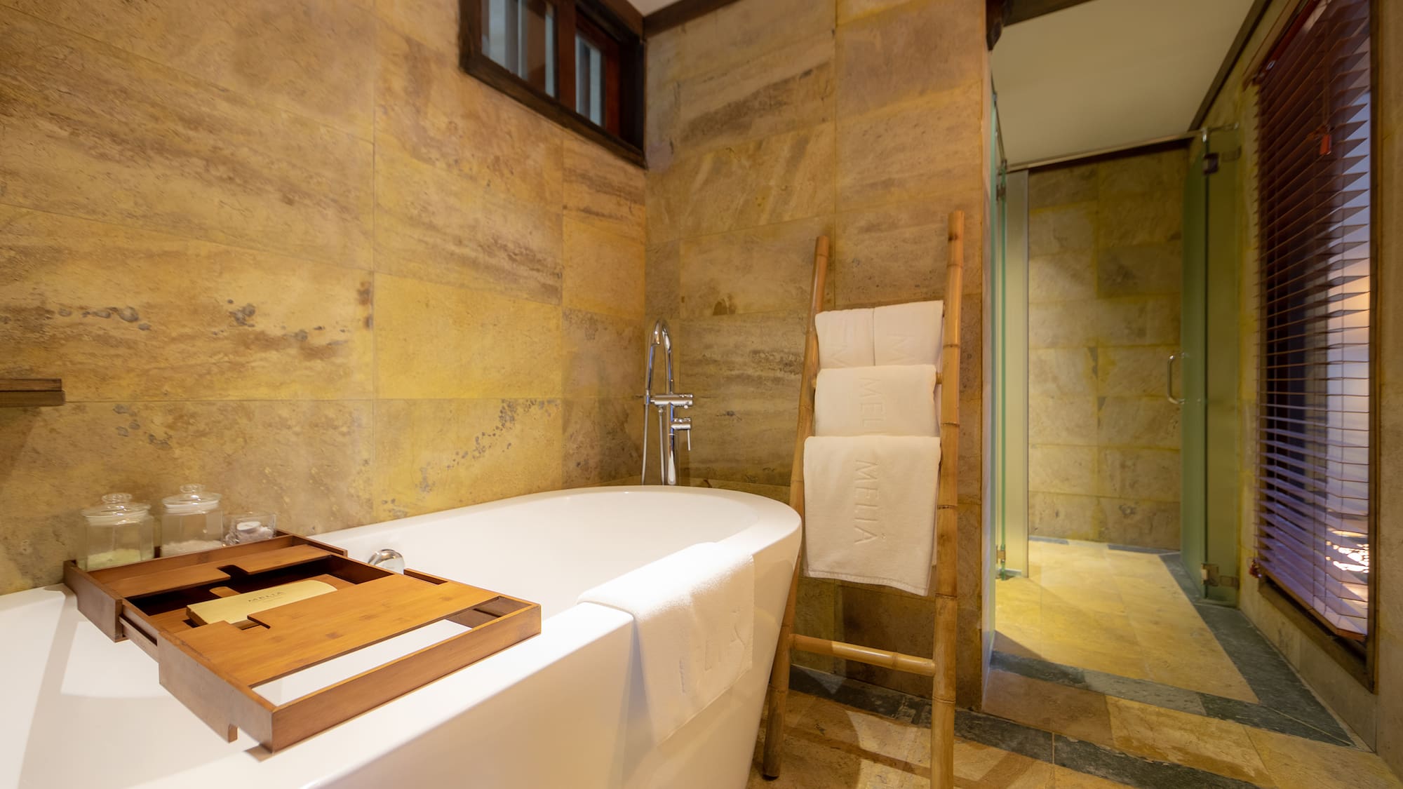 a bathroom with a tub and a wooden ladder