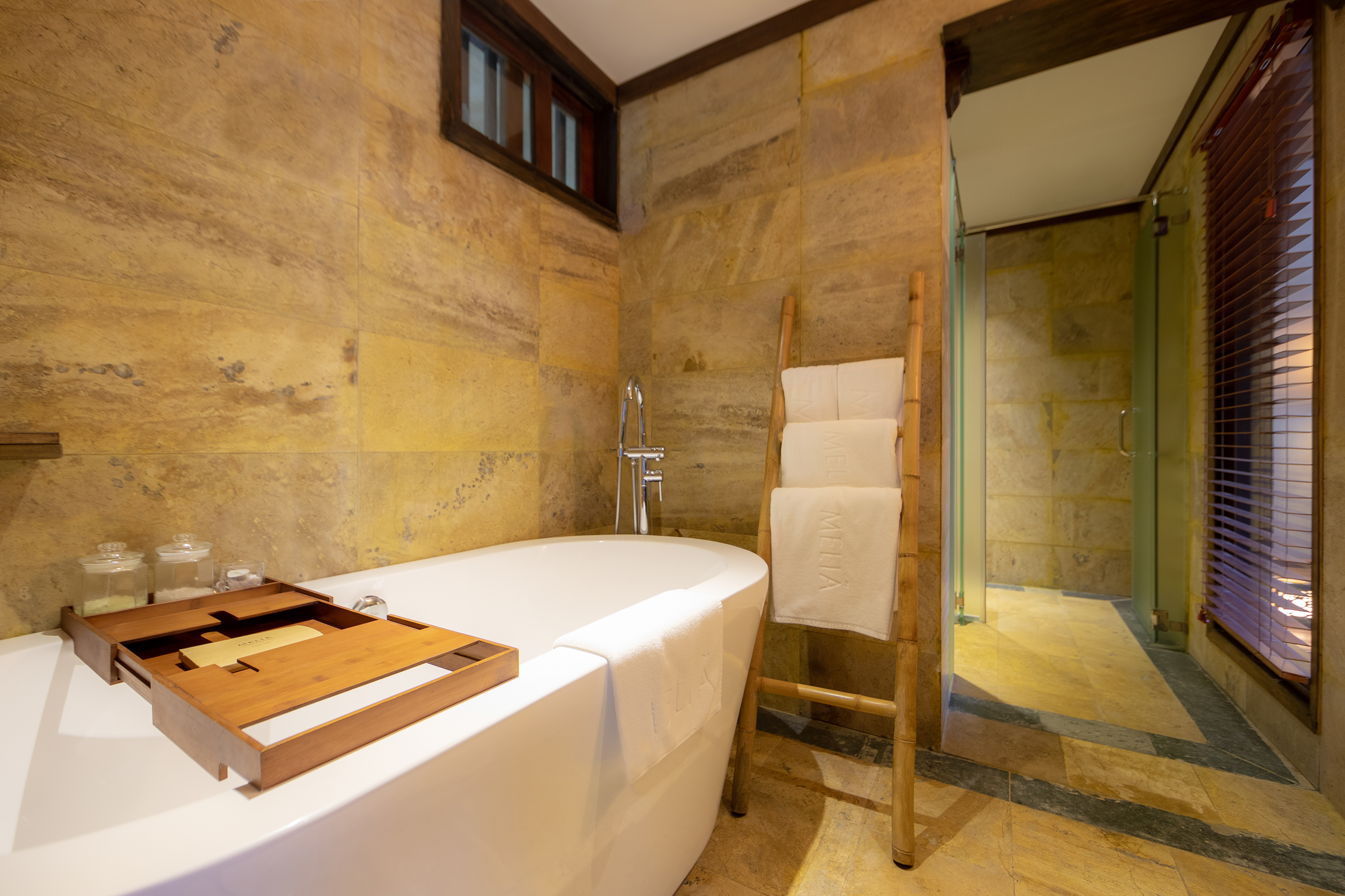 a bathroom with a tub and a wooden ladder