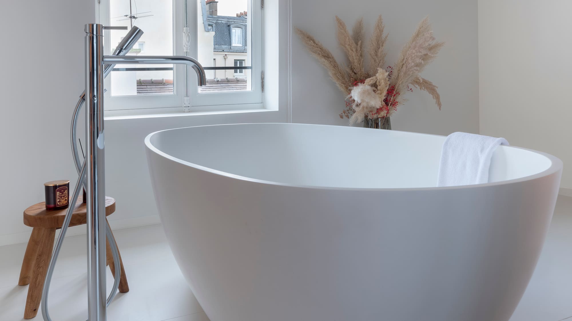 a white bathtub in a white bathroom