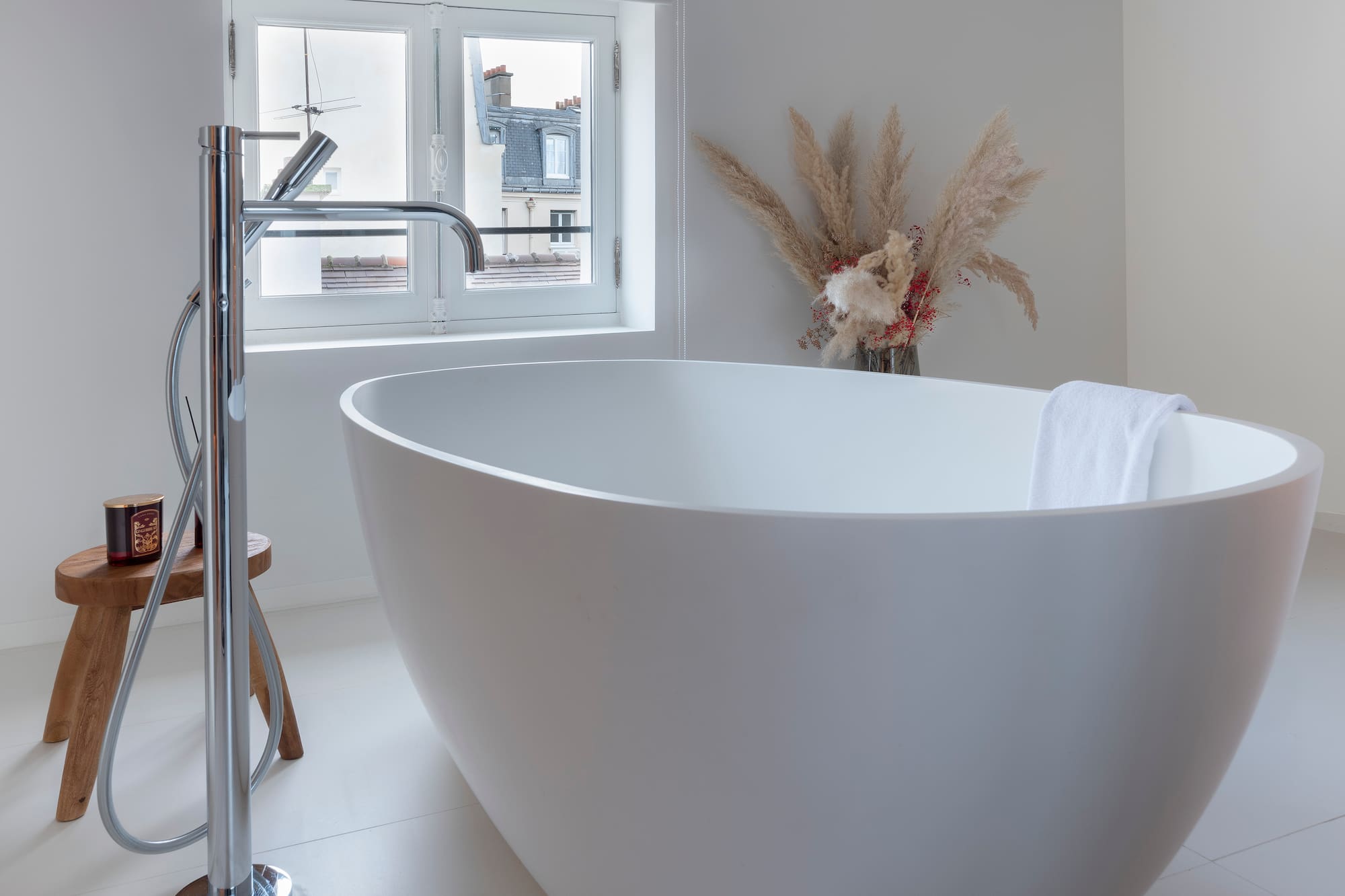 a white bathtub in a white bathroom