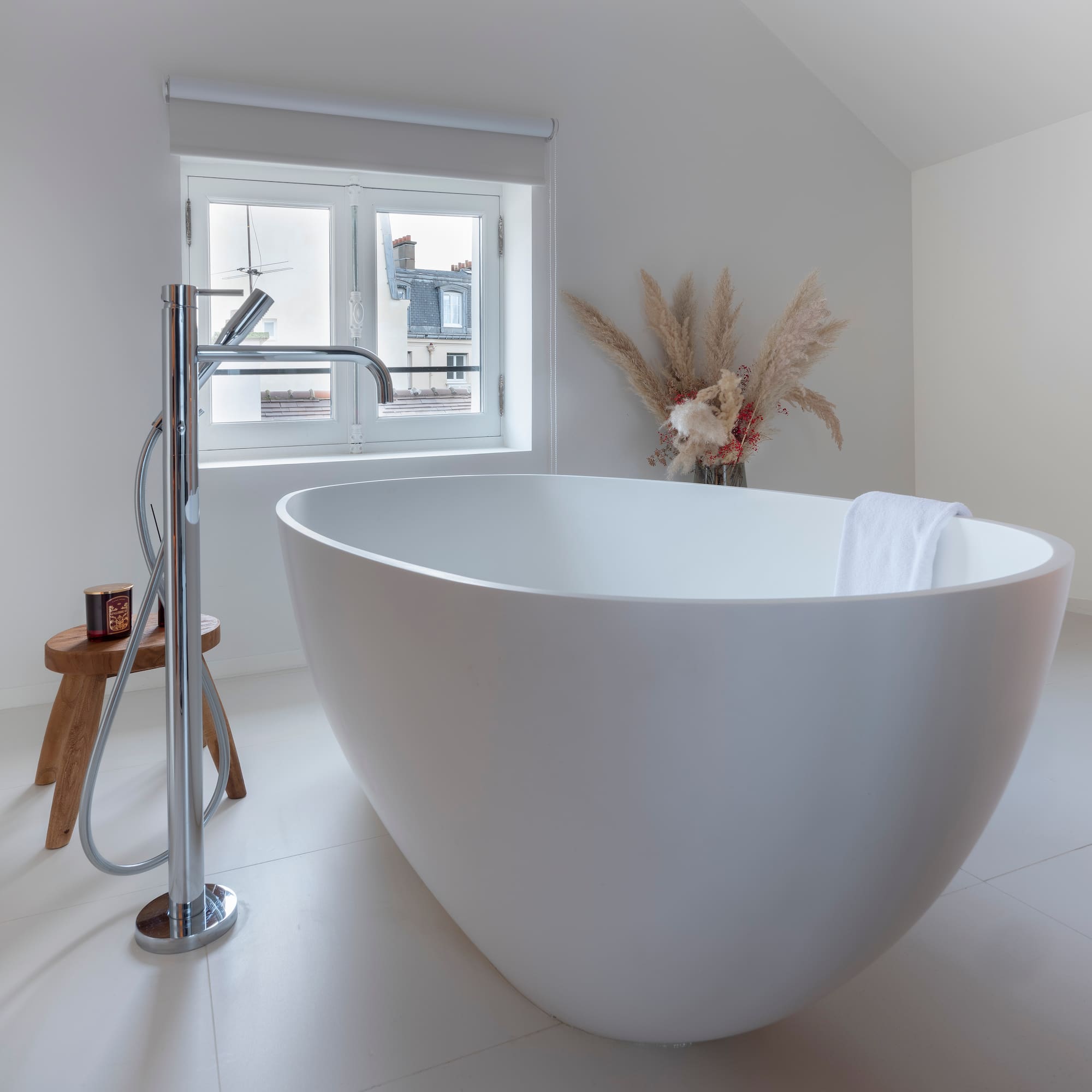 a white bathtub in a white bathroom