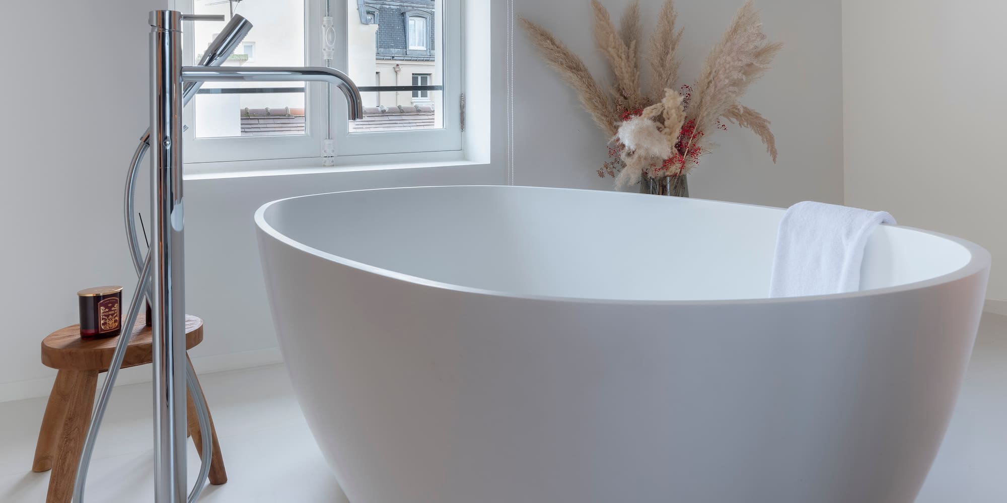 a white bathtub in a white bathroom