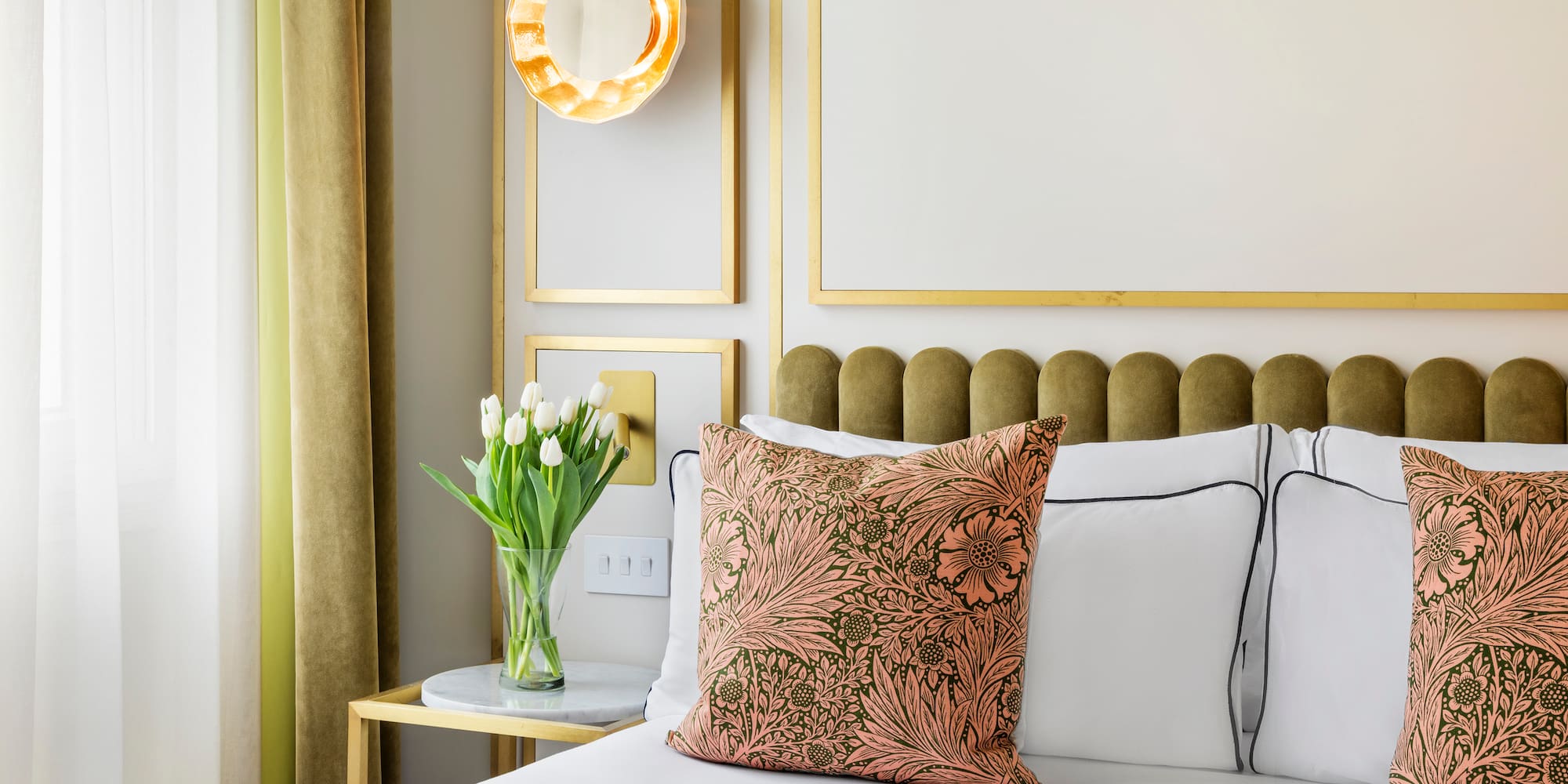 a bed with a vase of flowers