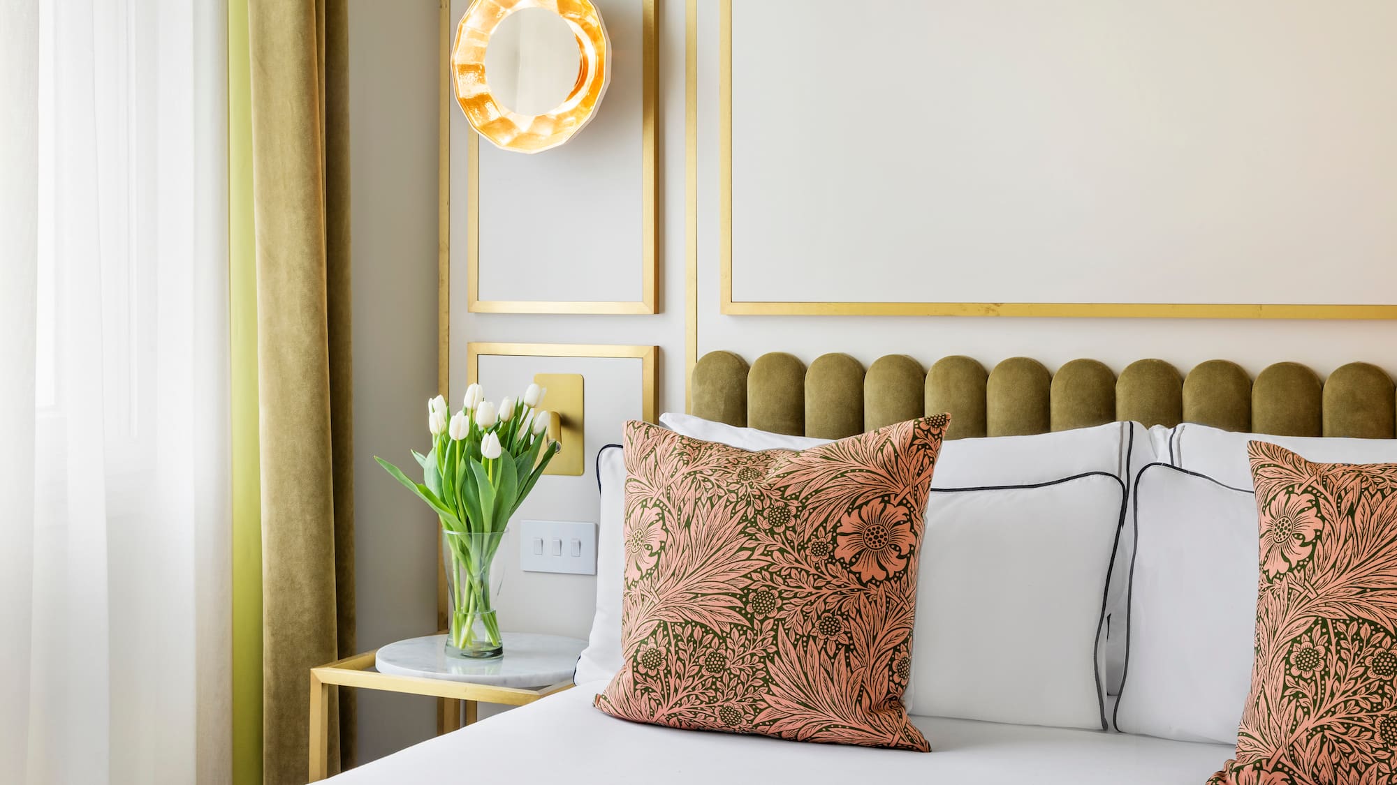 a bed with a vase of flowers