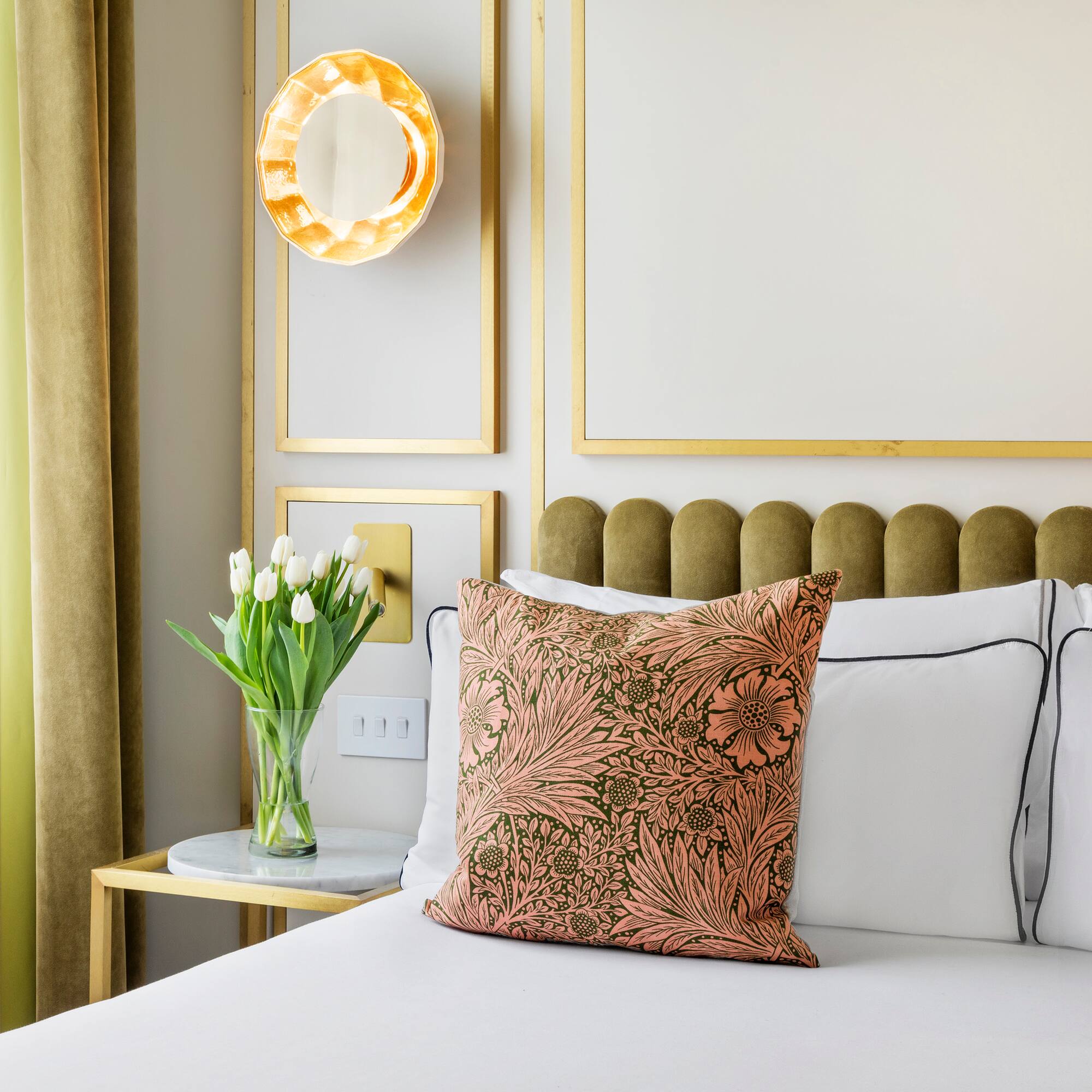 a bed with a vase of flowers