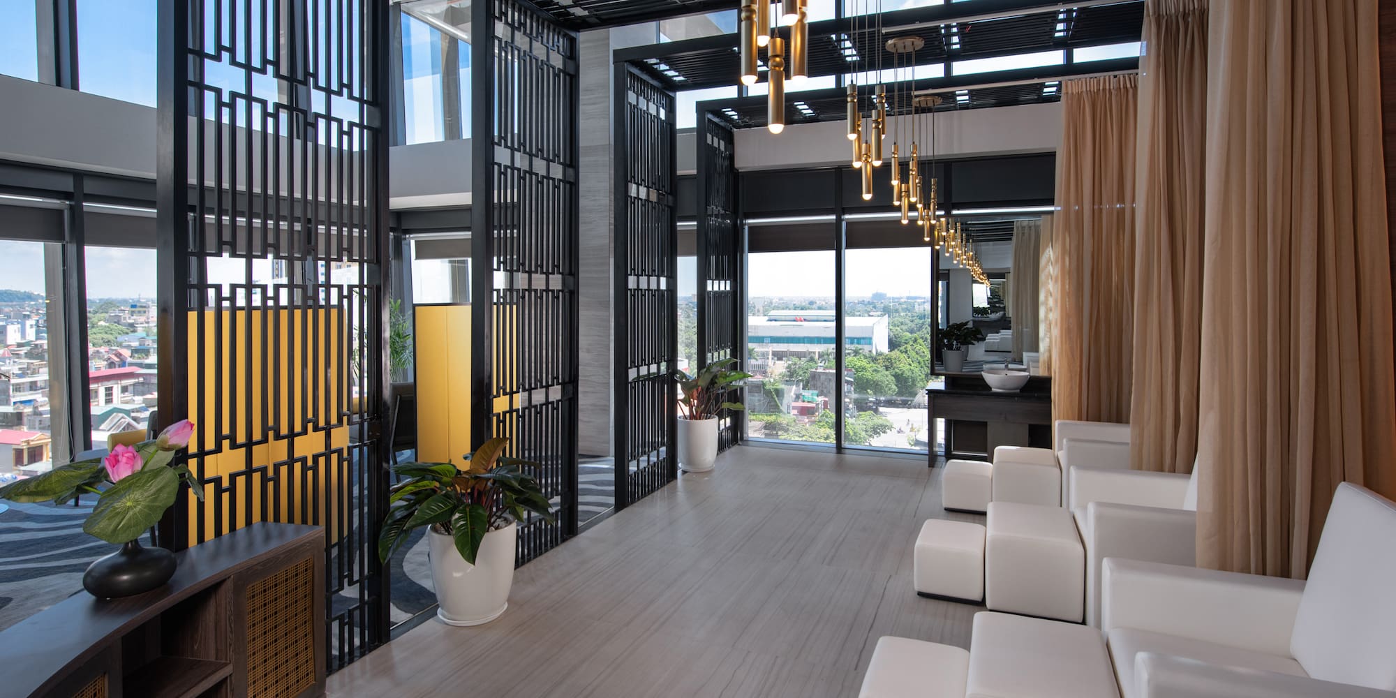 a room with white chairs and a black metal screen