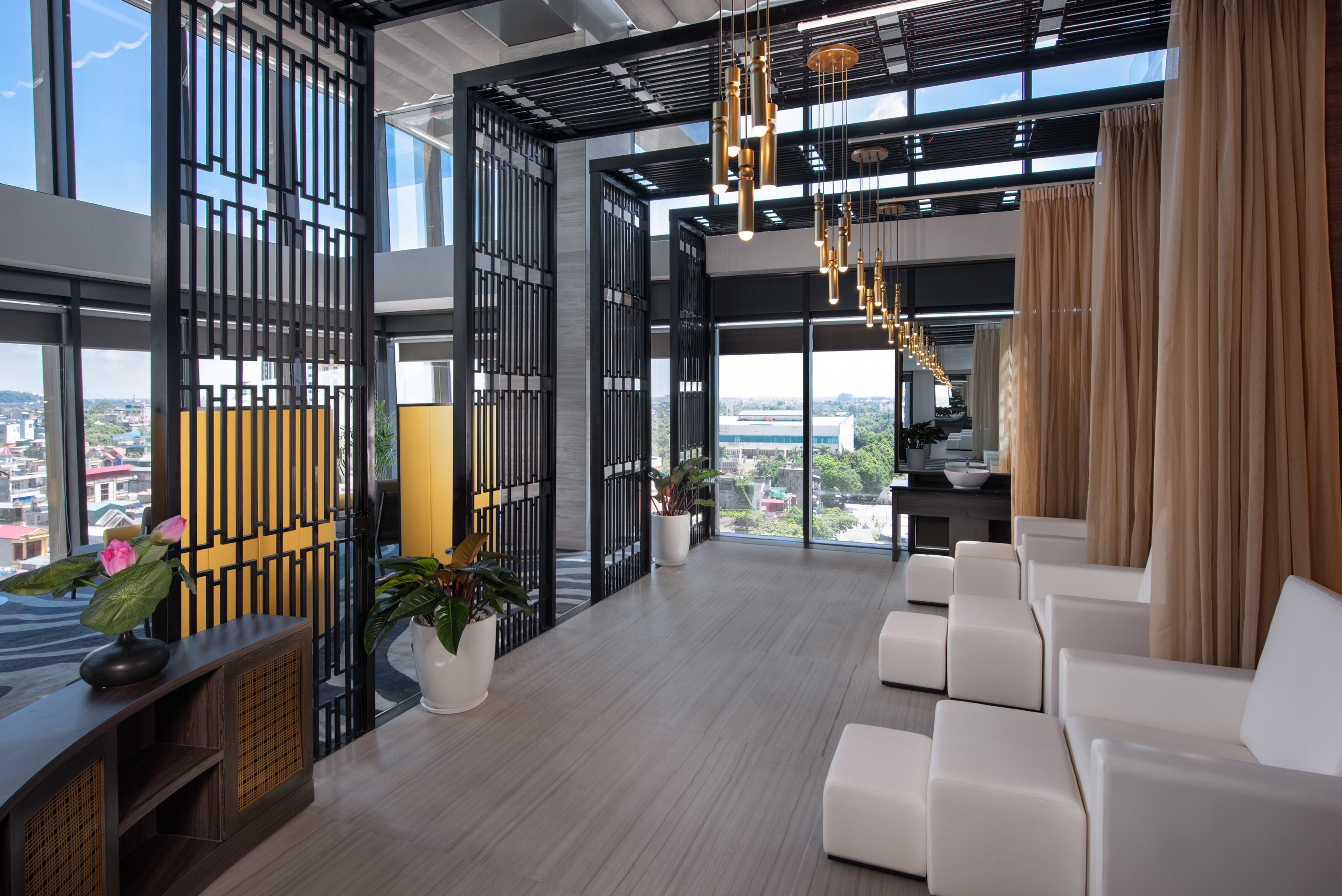 a room with white chairs and a black metal screen
