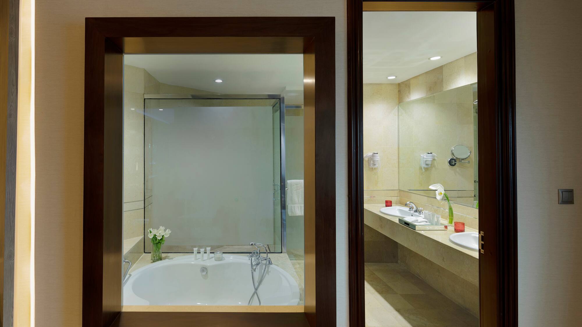 a bathroom with a tub and sinks