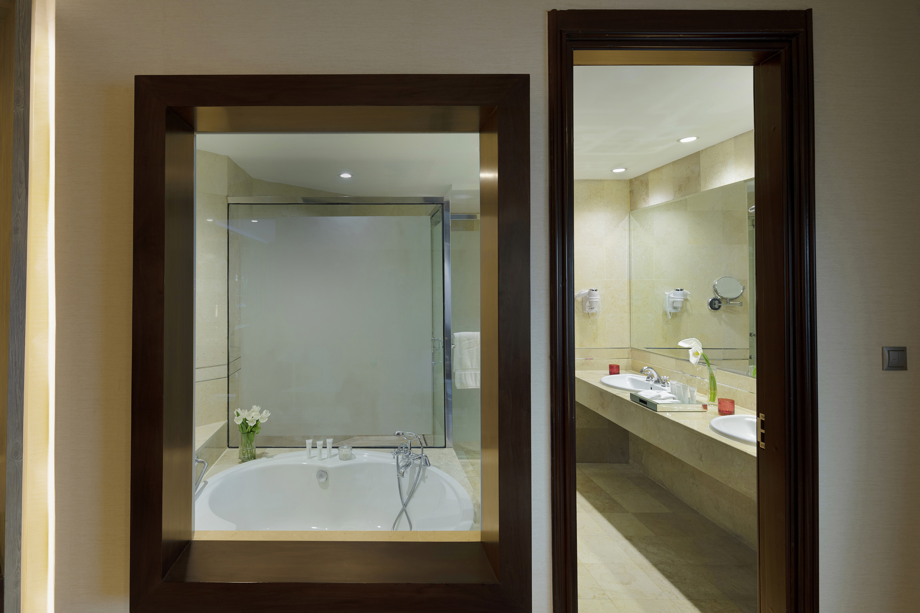 a bathroom with a tub and sinks