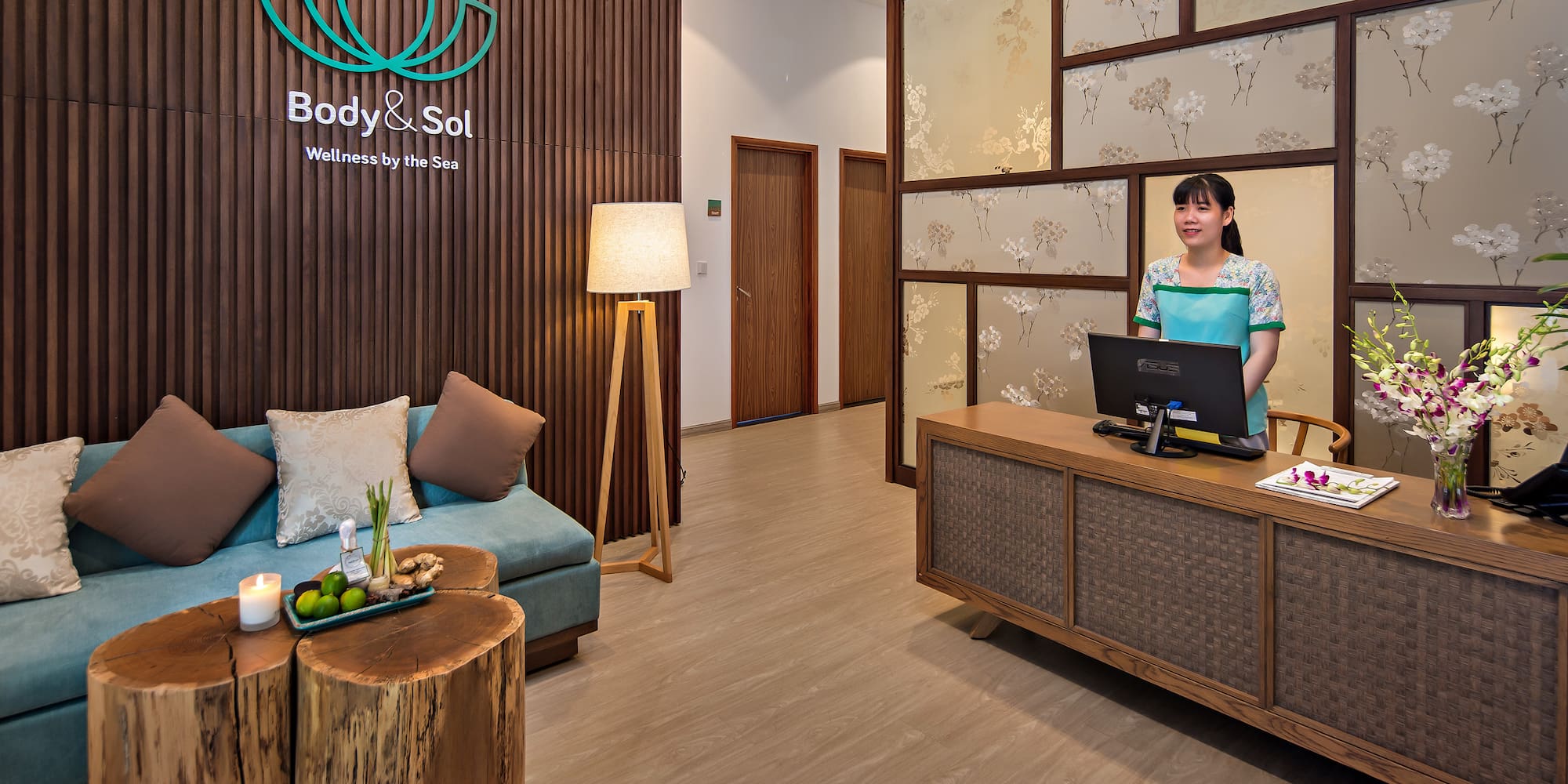 a woman standing behind a desk in a hotel lobby