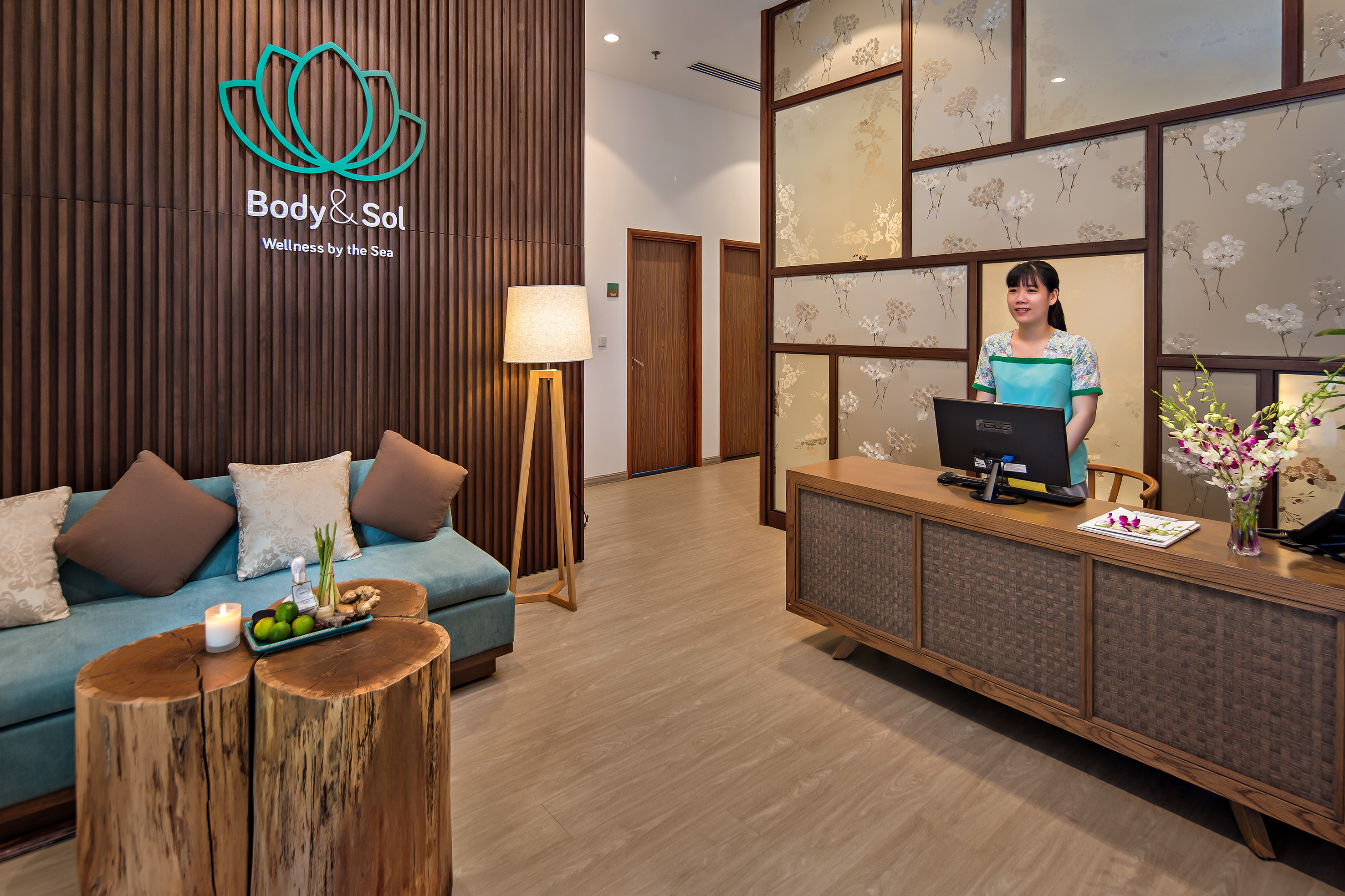 a woman standing behind a desk in a hotel lobby