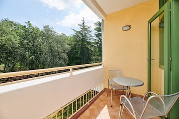 a table and chairs on a balcony
