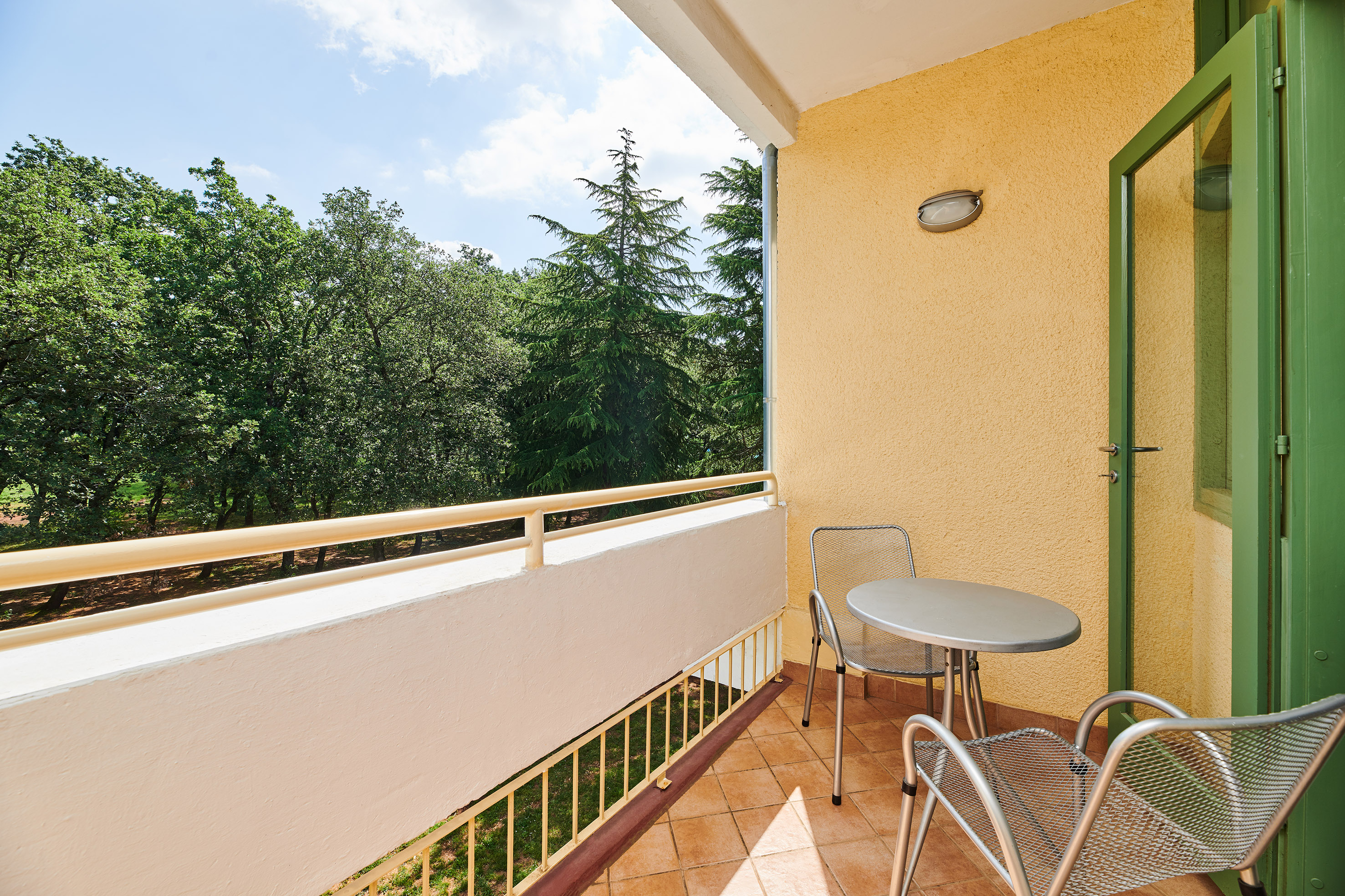 a table and chairs on a balcony