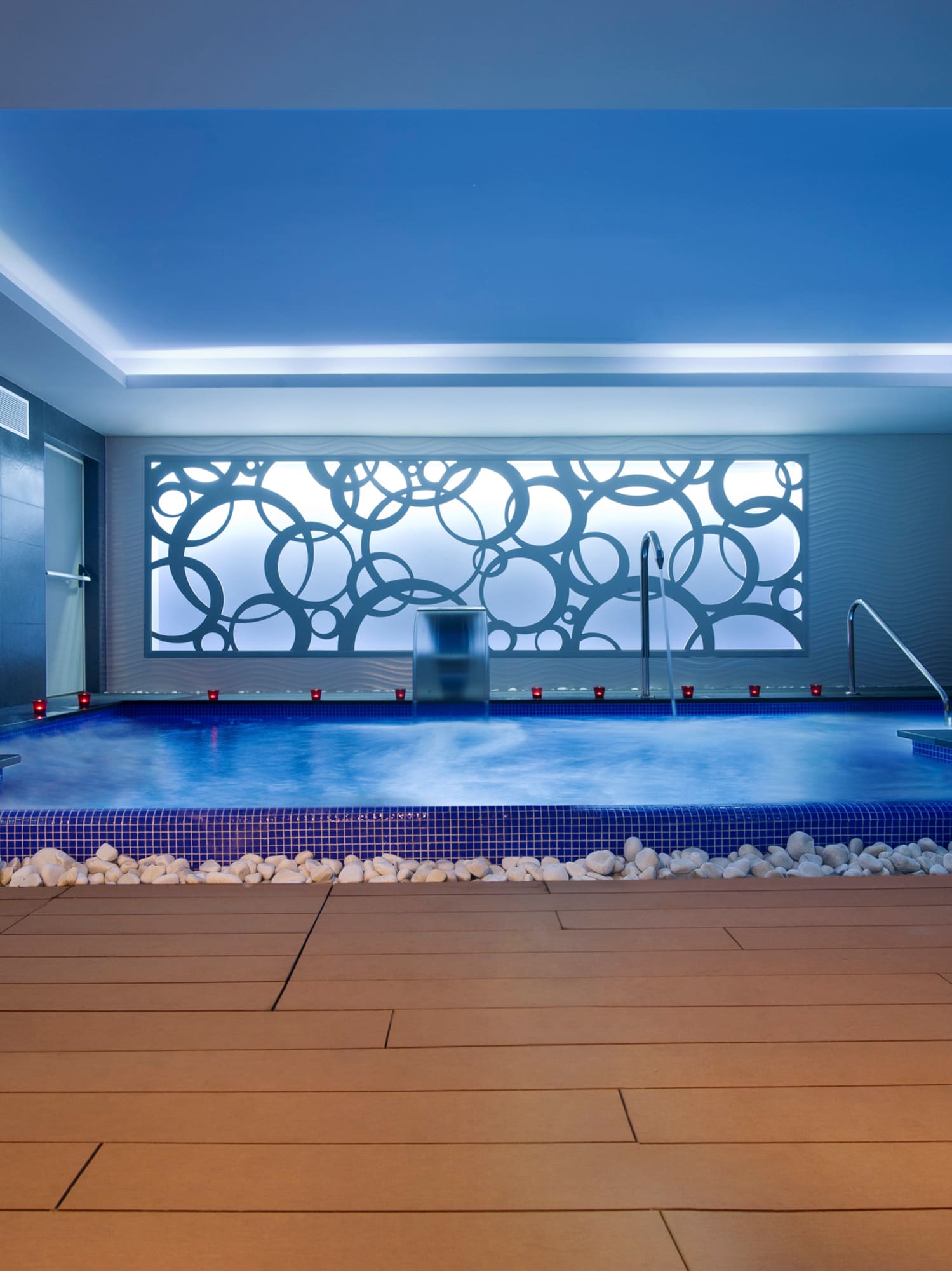 a indoor pool with a large stone floor