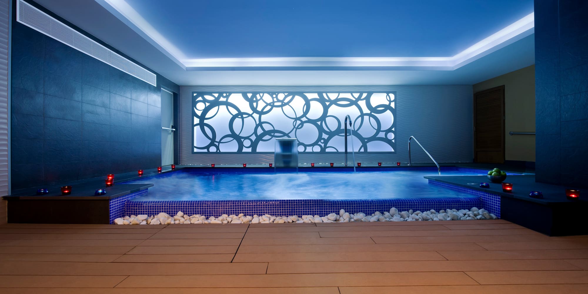 a indoor pool with a large stone floor