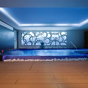 a indoor pool with a large stone floor