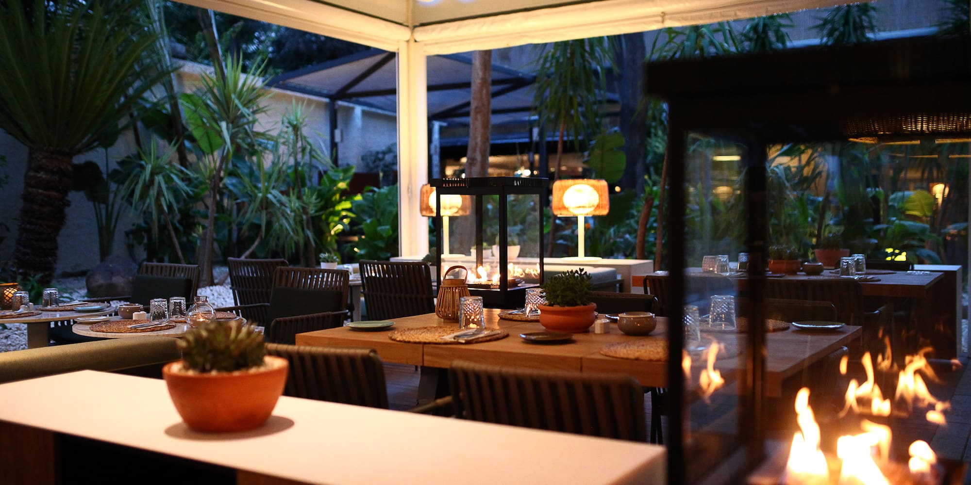 a table with chairs and a fire in the middle