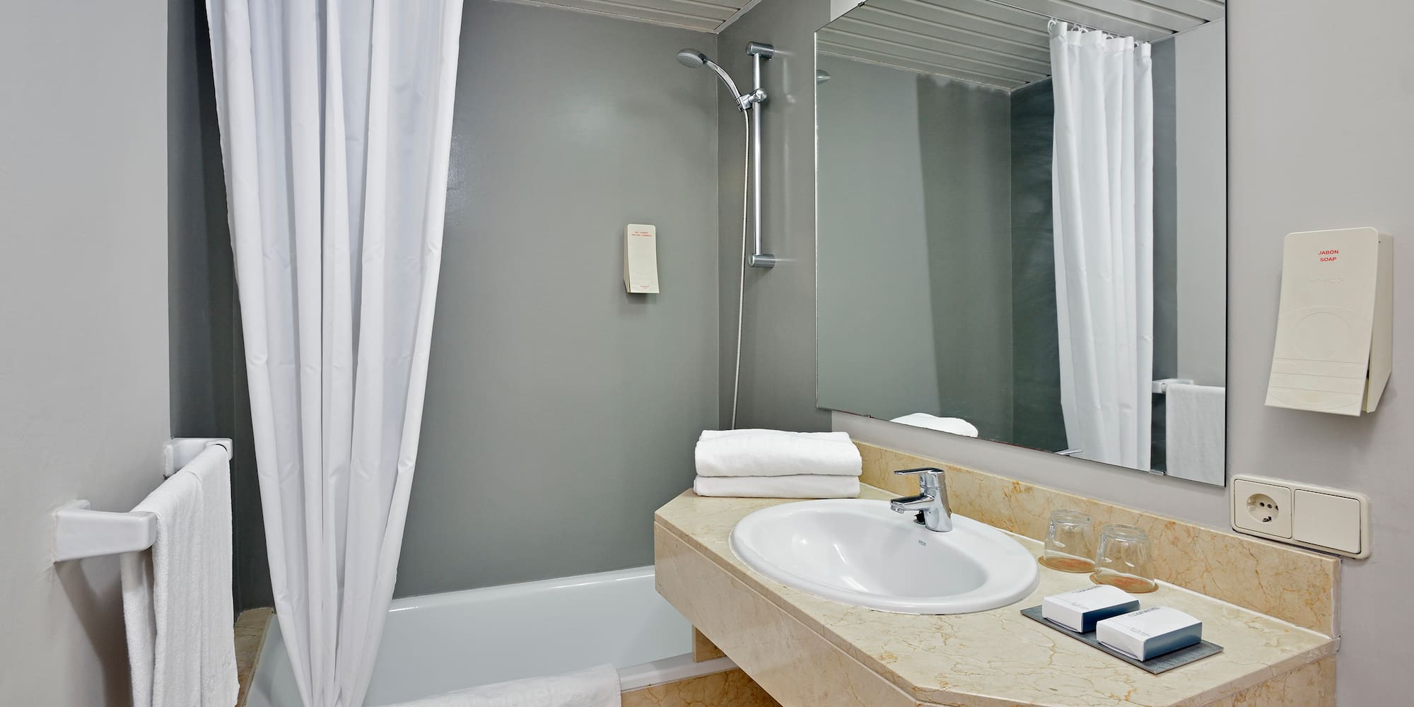 a bathroom with a sink and shower curtain