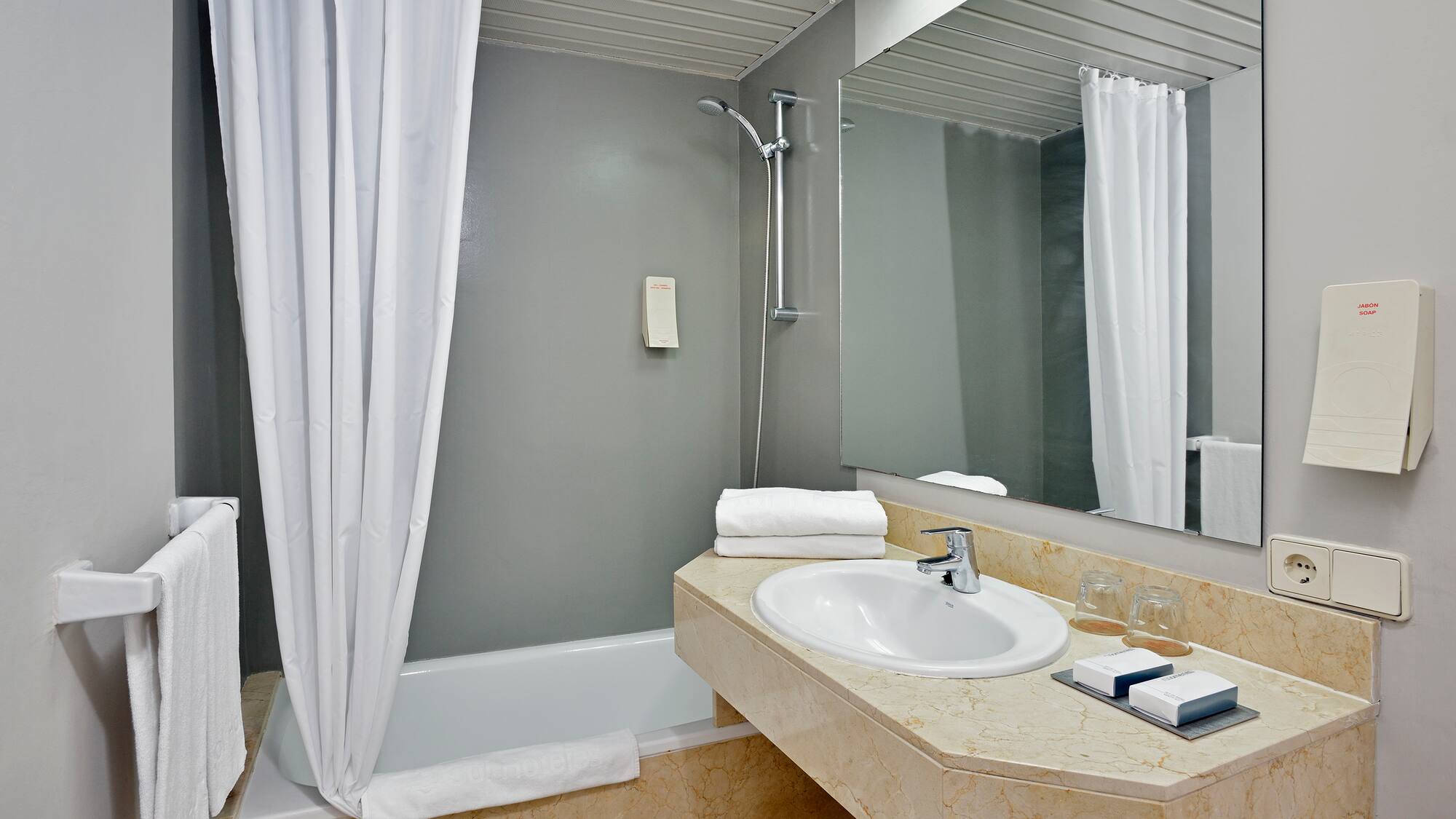 a bathroom with a sink and shower curtain
