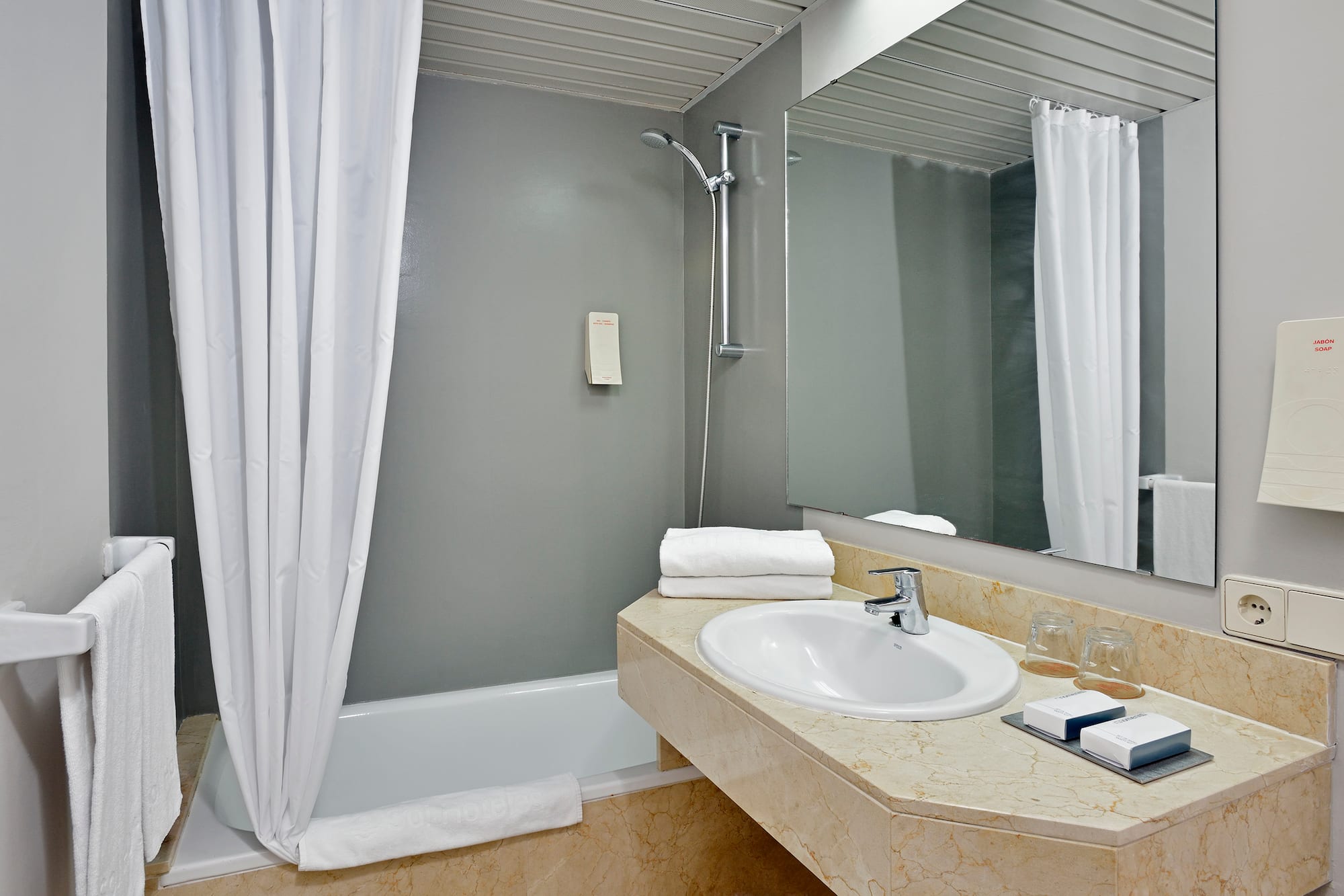 a bathroom with a sink and shower curtain