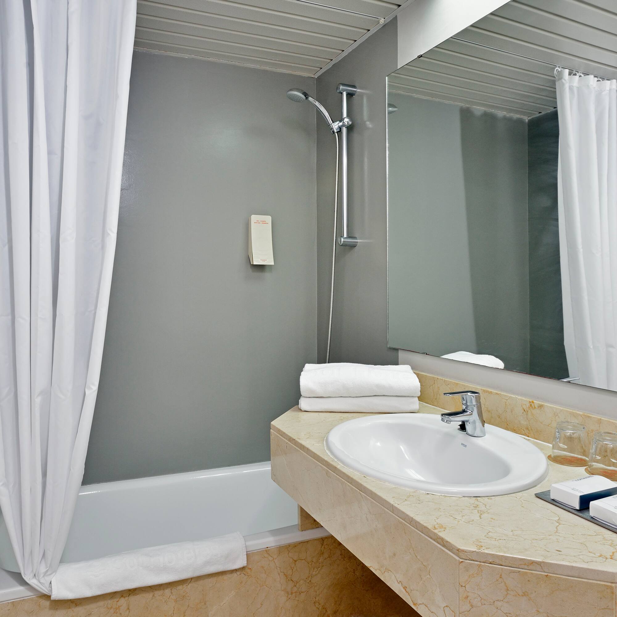 a bathroom with a sink and shower curtain