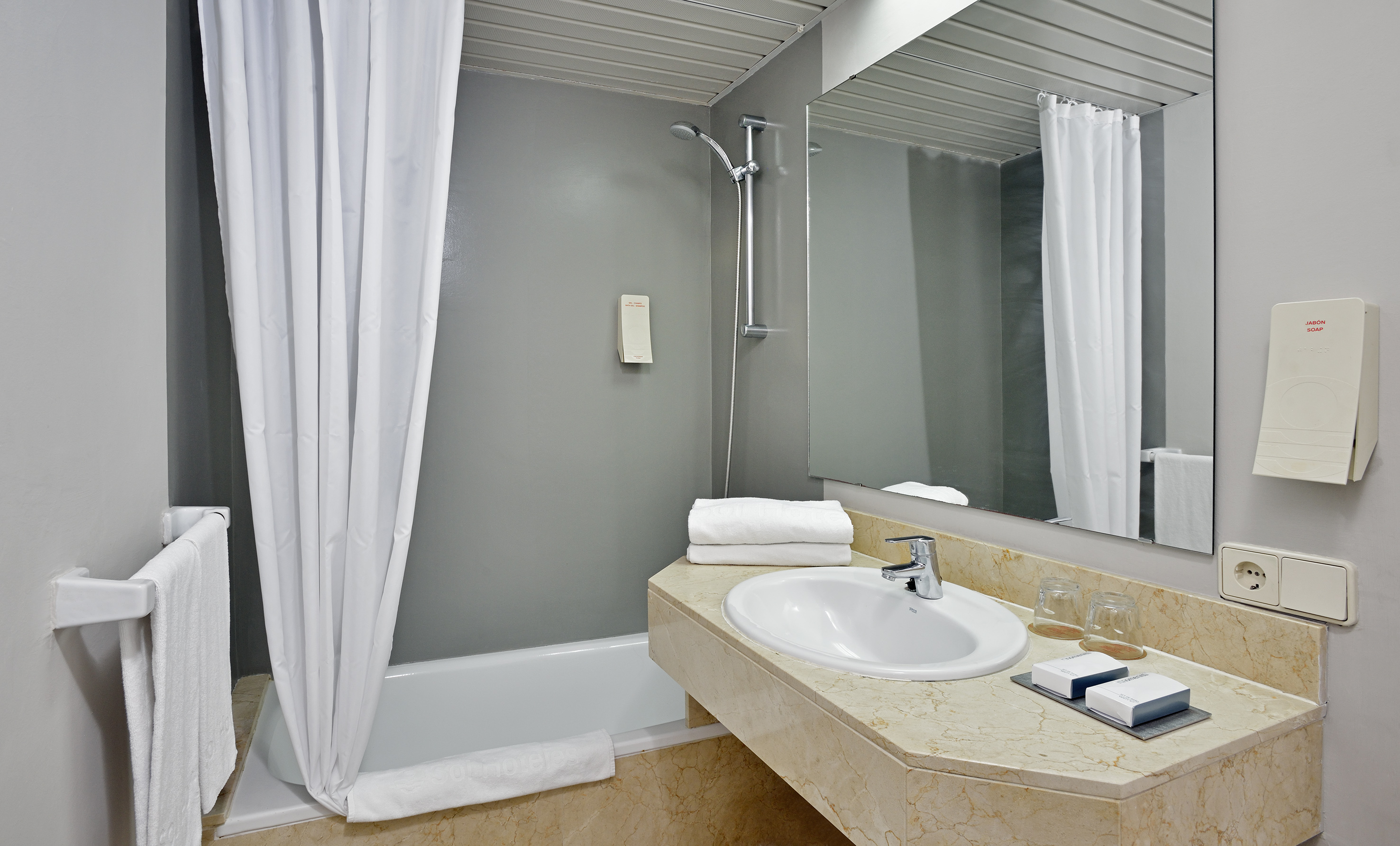 a bathroom with a sink and shower curtain