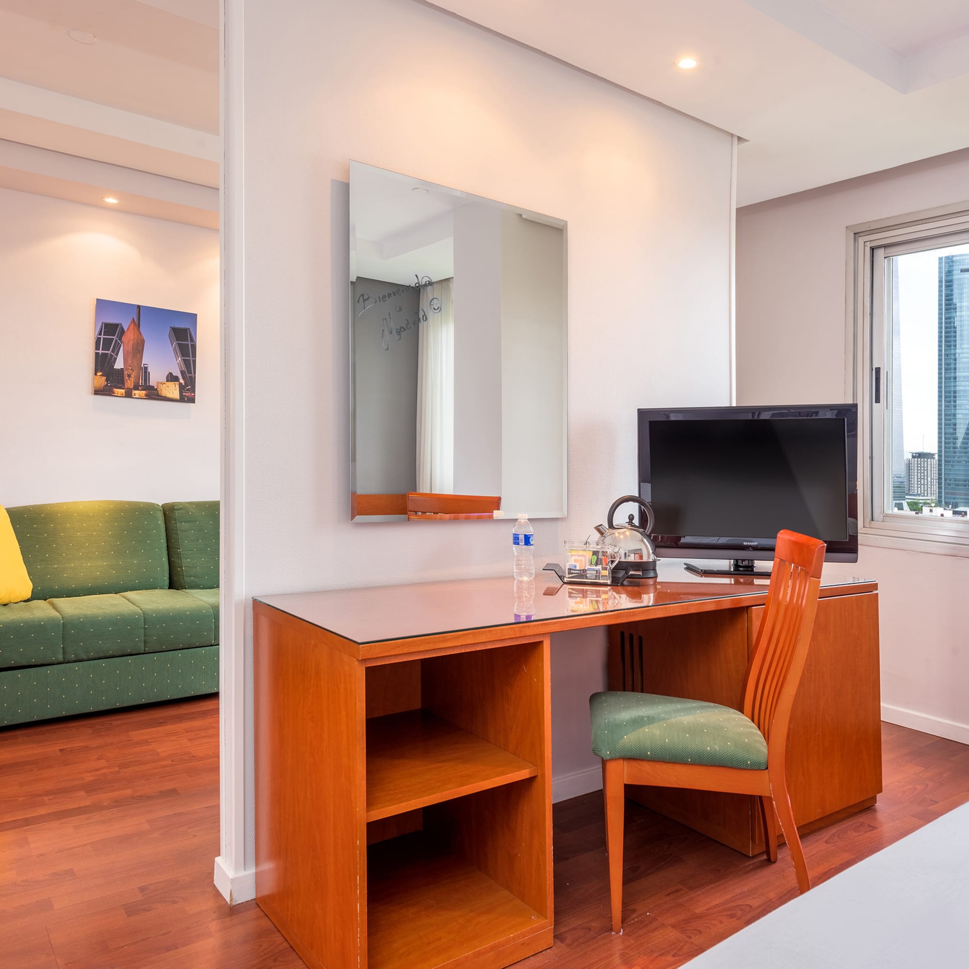 a room with a desk and a green couch