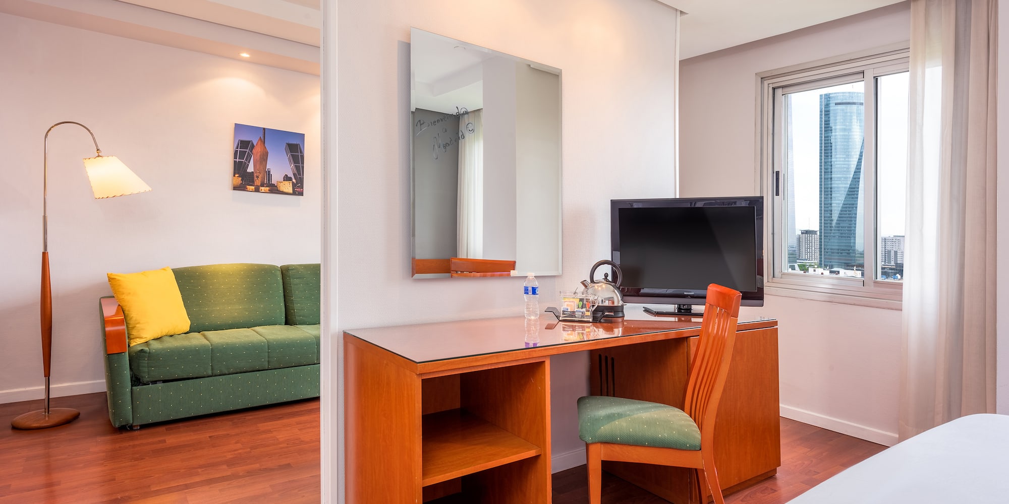 a room with a desk and a green couch