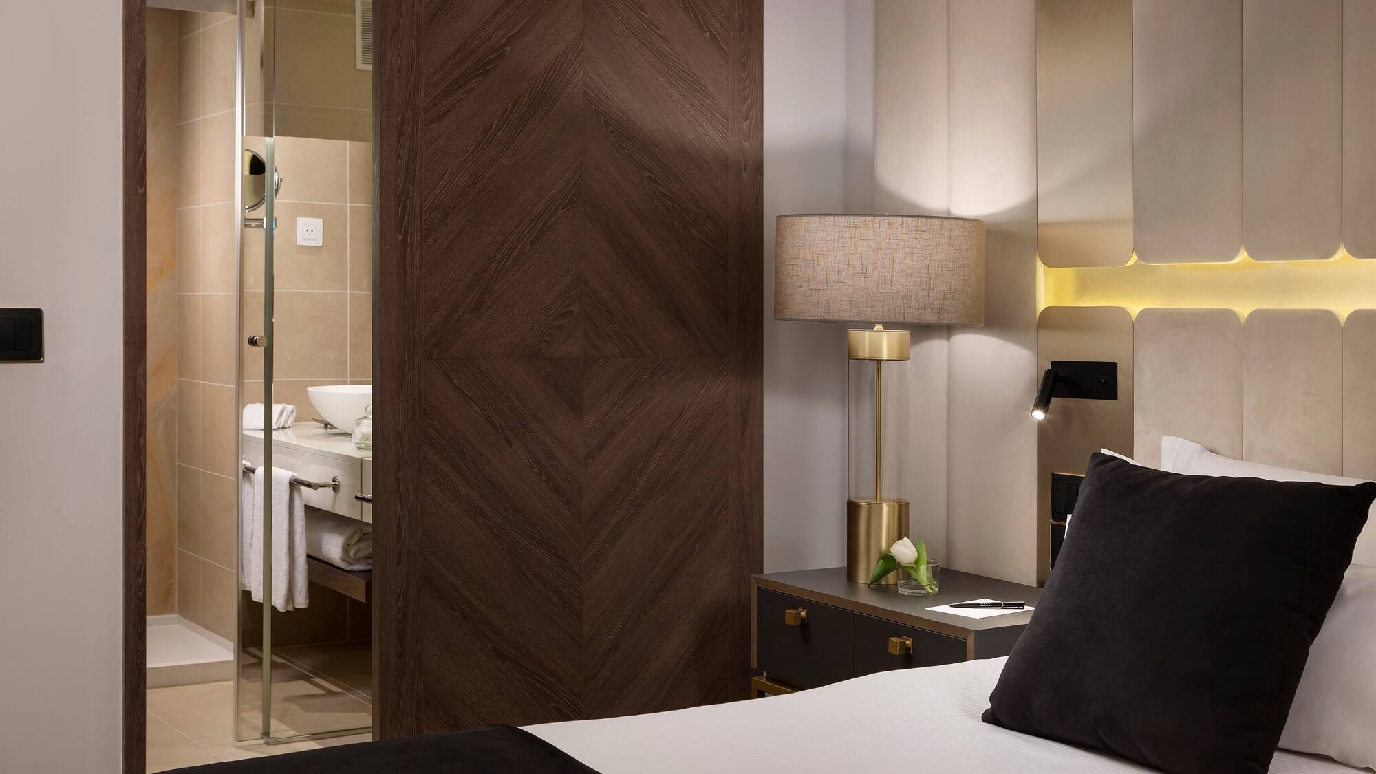 a bedroom with a glass door and a mirror