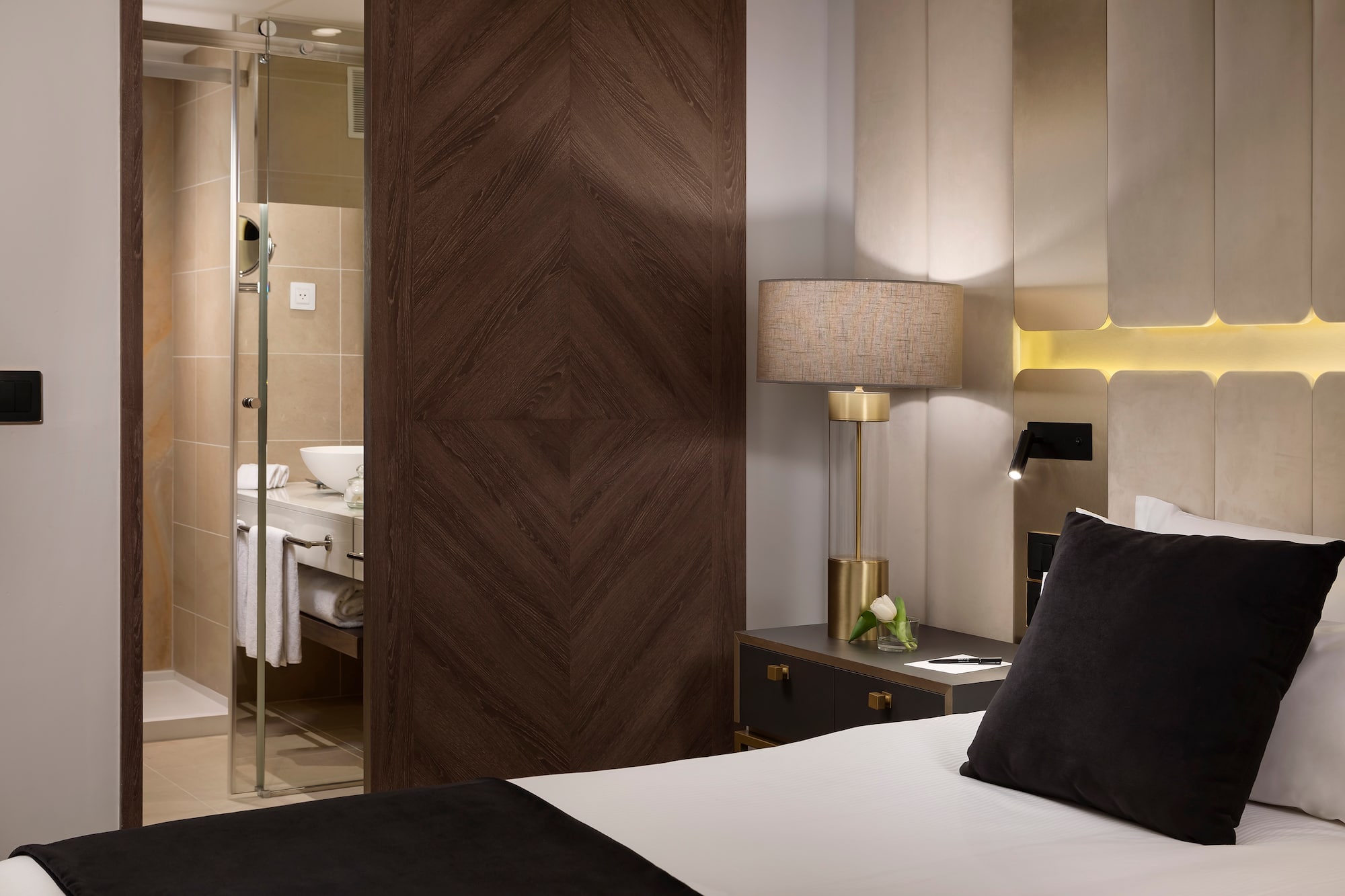 a bedroom with a glass door and a mirror