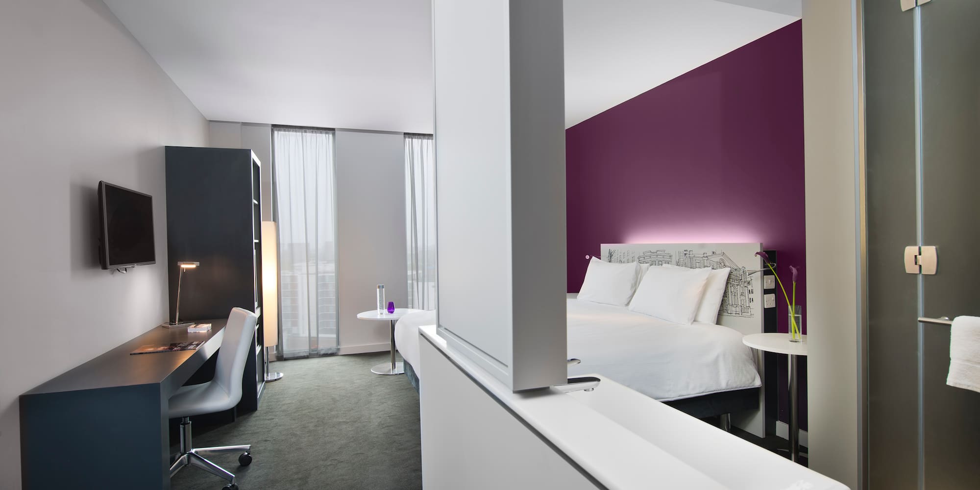 a room with a bed and a desk