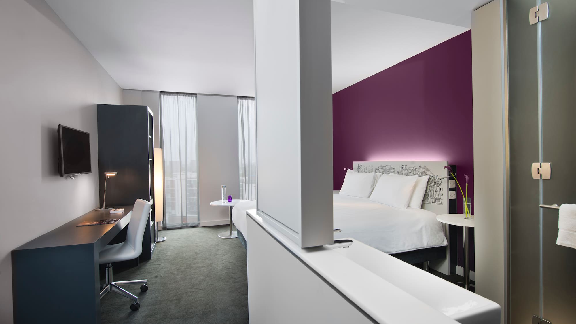 a room with a bed and a desk