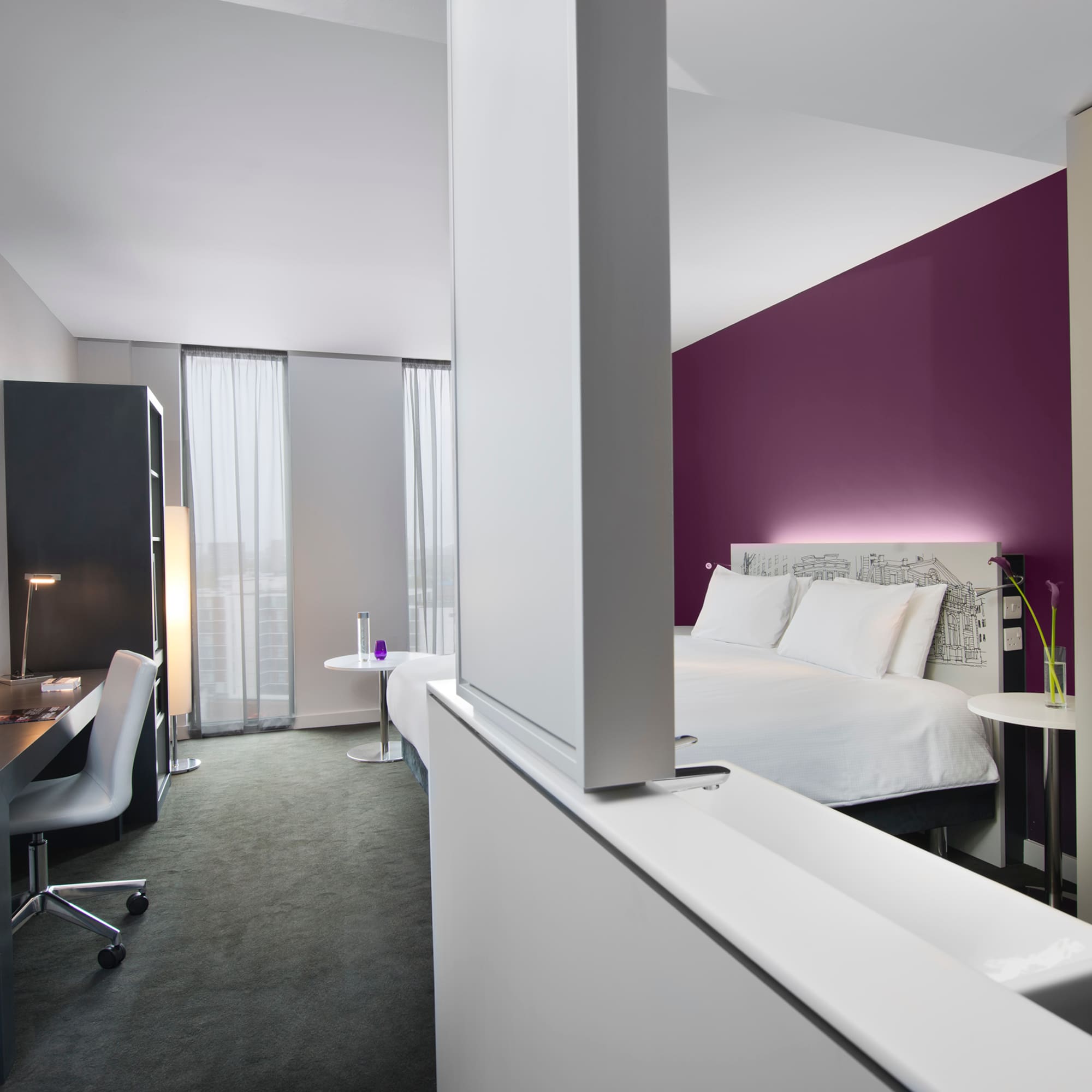 a room with a bed and a desk