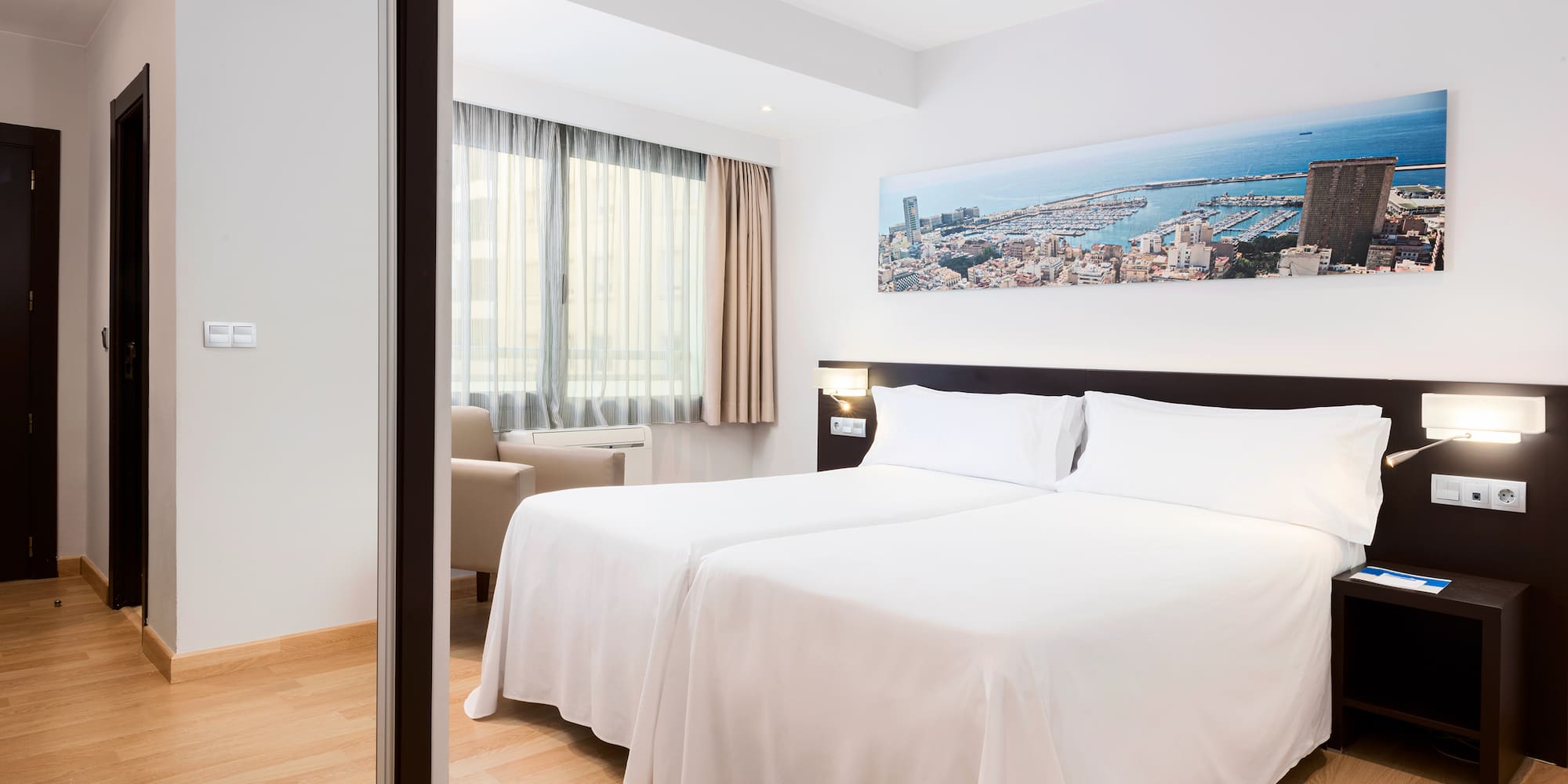 a room with two beds and a mirror